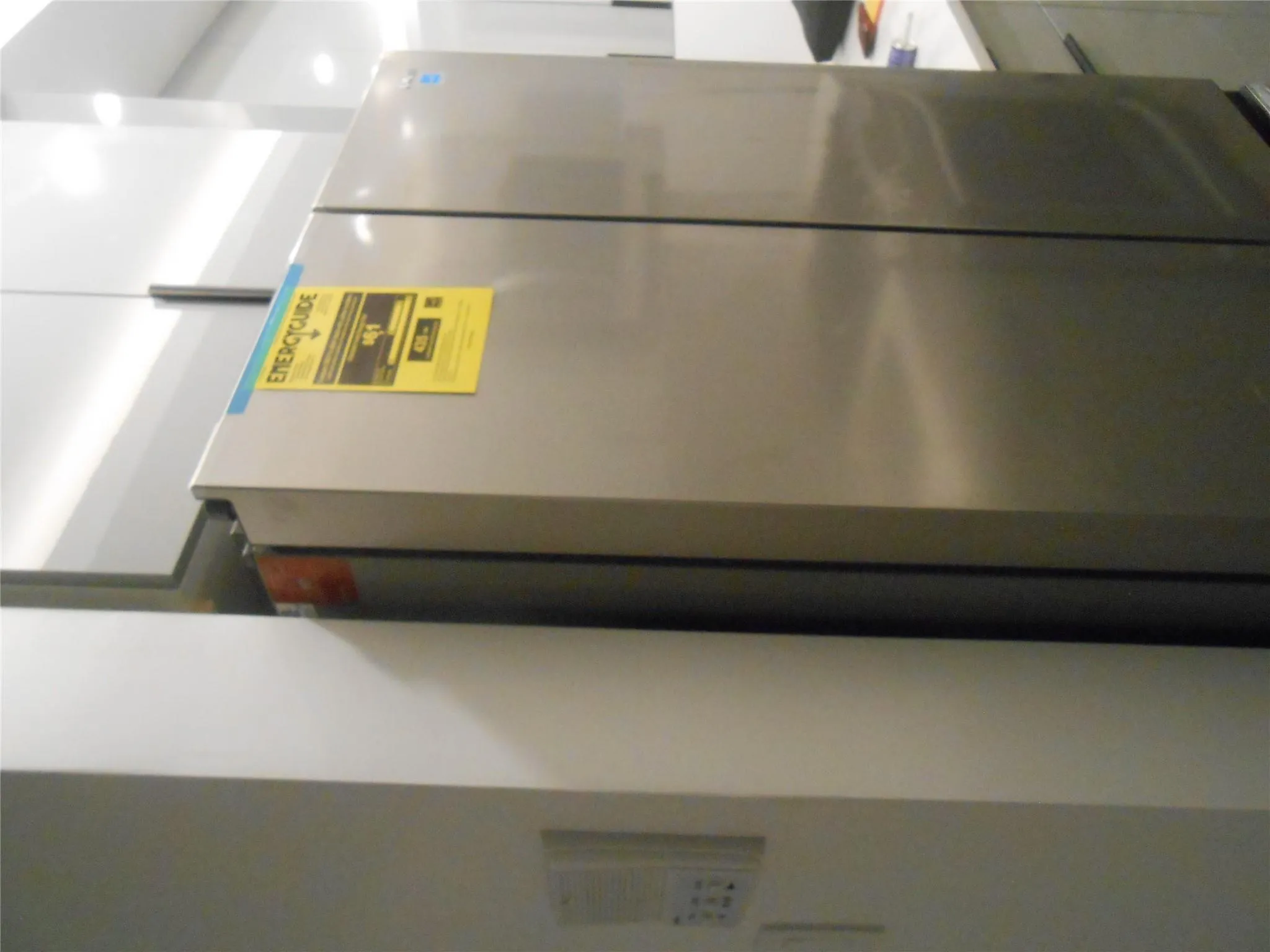 Detailed view of fridge and light countertops Detailed view of fridge and light countertops