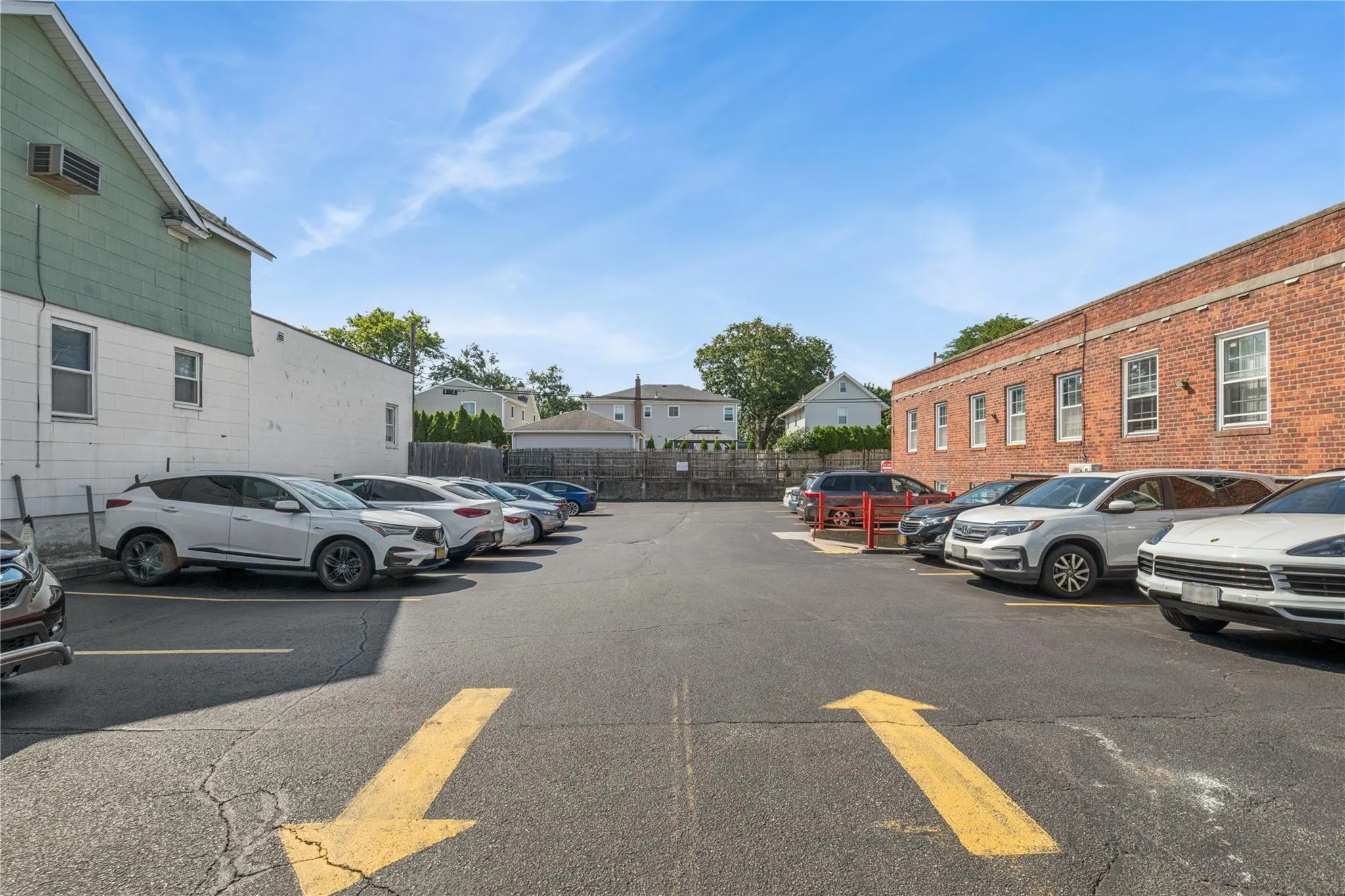 Uncovered parking lot with a residential view and an AC wall unit Uncovered parking lot with a residential view and an AC wall unit