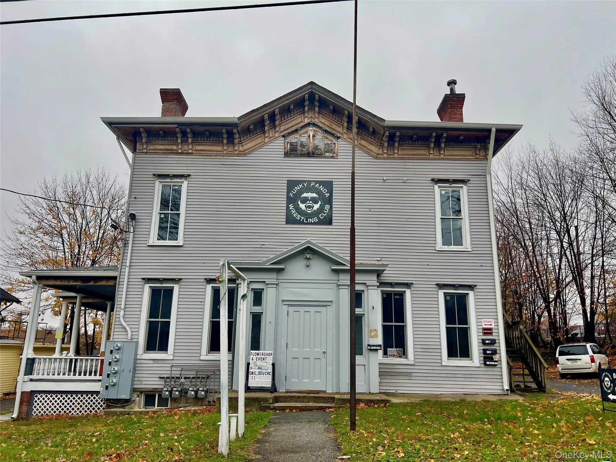 Italianate house with a chimney and a front yard Italianate house with a chimney and a front yard