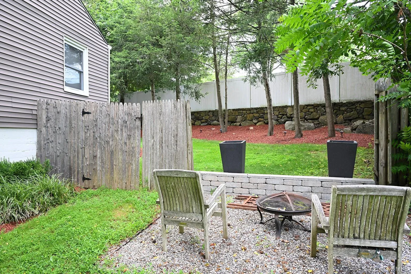 View of yard featuring a fire pit View of yard featuring a fire pit