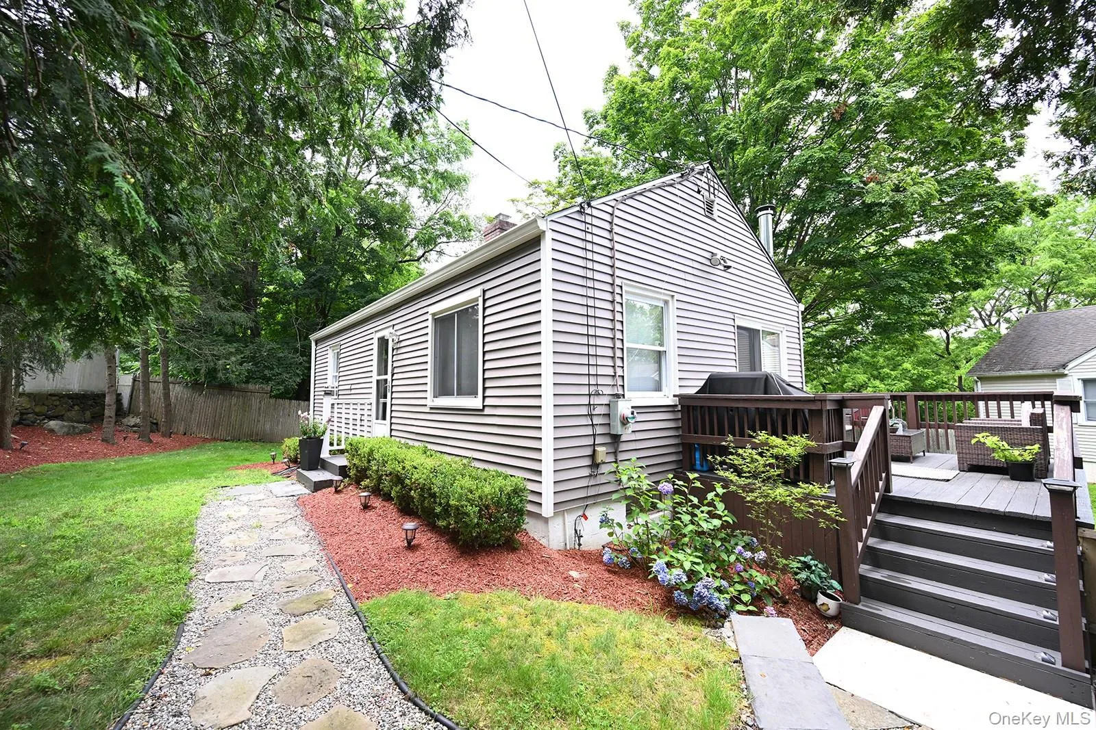View of front of house featuring a wooden deck View of front of house featuring a wooden deck