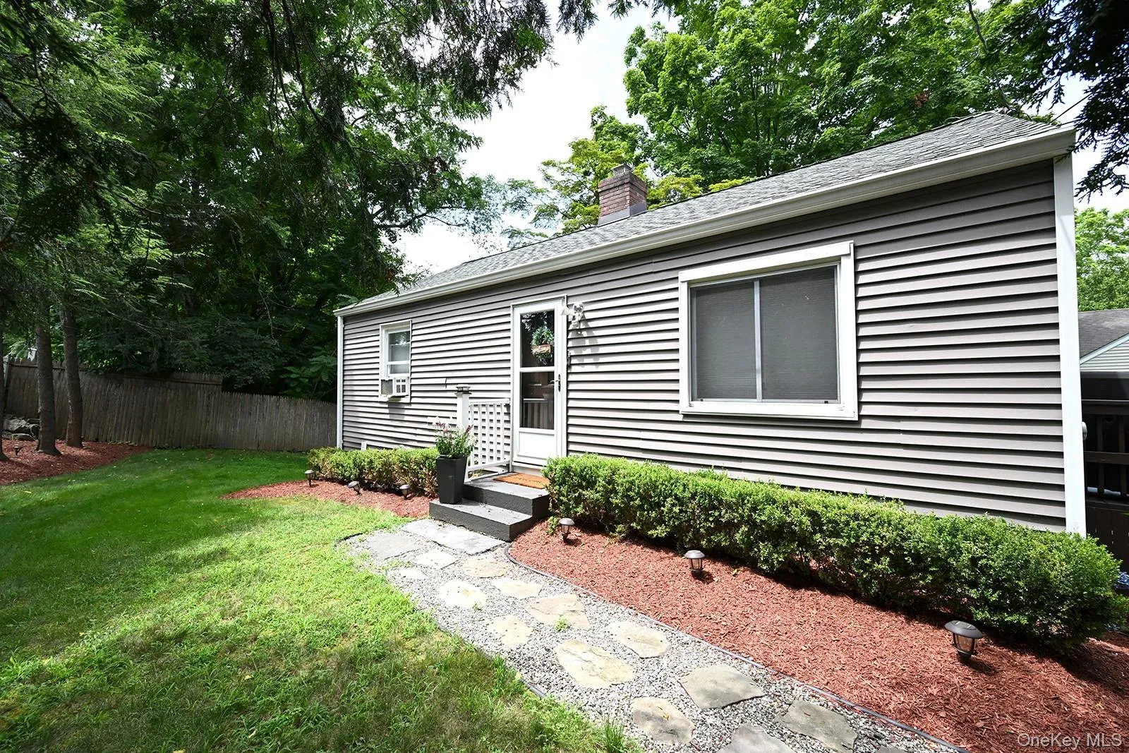 View of front of property with a shingled roof and a chimney View of front of property with a shingled roof and a chimney