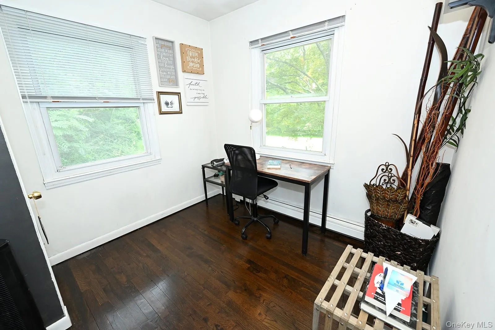 Office area with dark wood-type flooring and baseboards Office area with dark wood-type flooring and baseboards