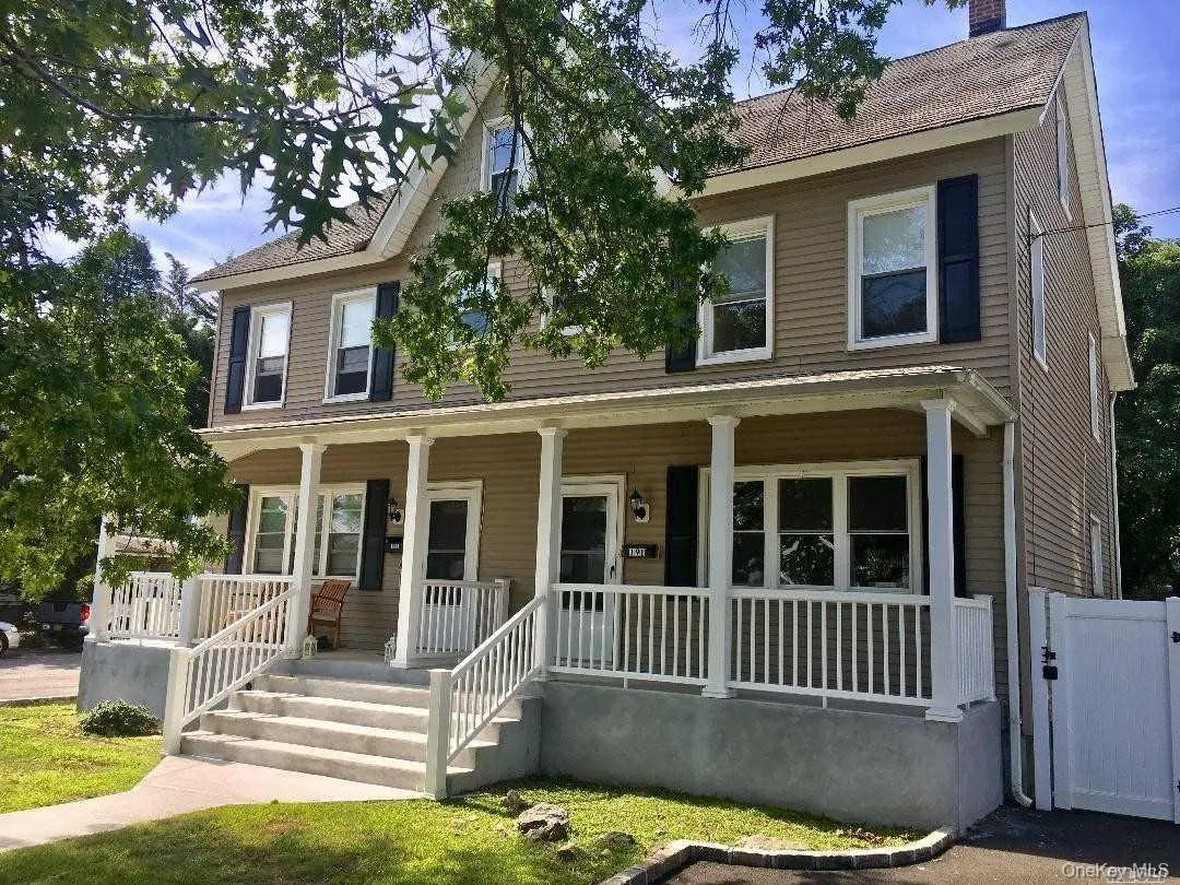 Colonial-style house featuring covered porch Colonial-style house featuring covered porch