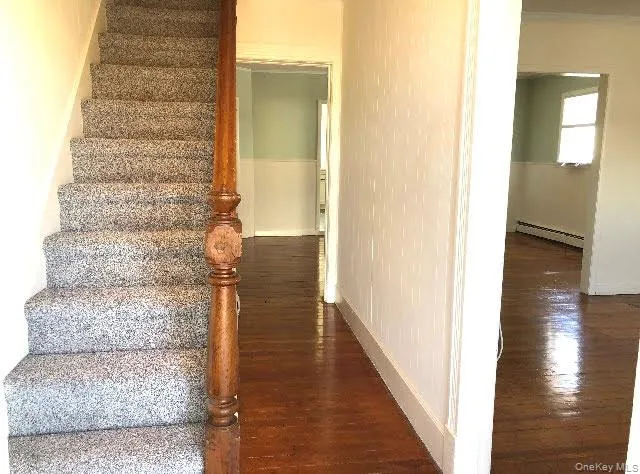 Stairway featuring wood finished floors Stairway featuring wood finished floors
