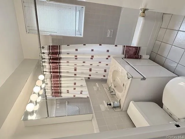 Full bath with tile patterned floors, vanity, shower / bath combo. Full bath with tile patterned floors, vanity, shower / bath combo.