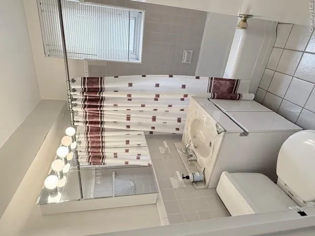Full bath with tile patterned floors, vanity, shower / bath combo. Full bath with tile patterned floors, vanity, shower / bath combo.