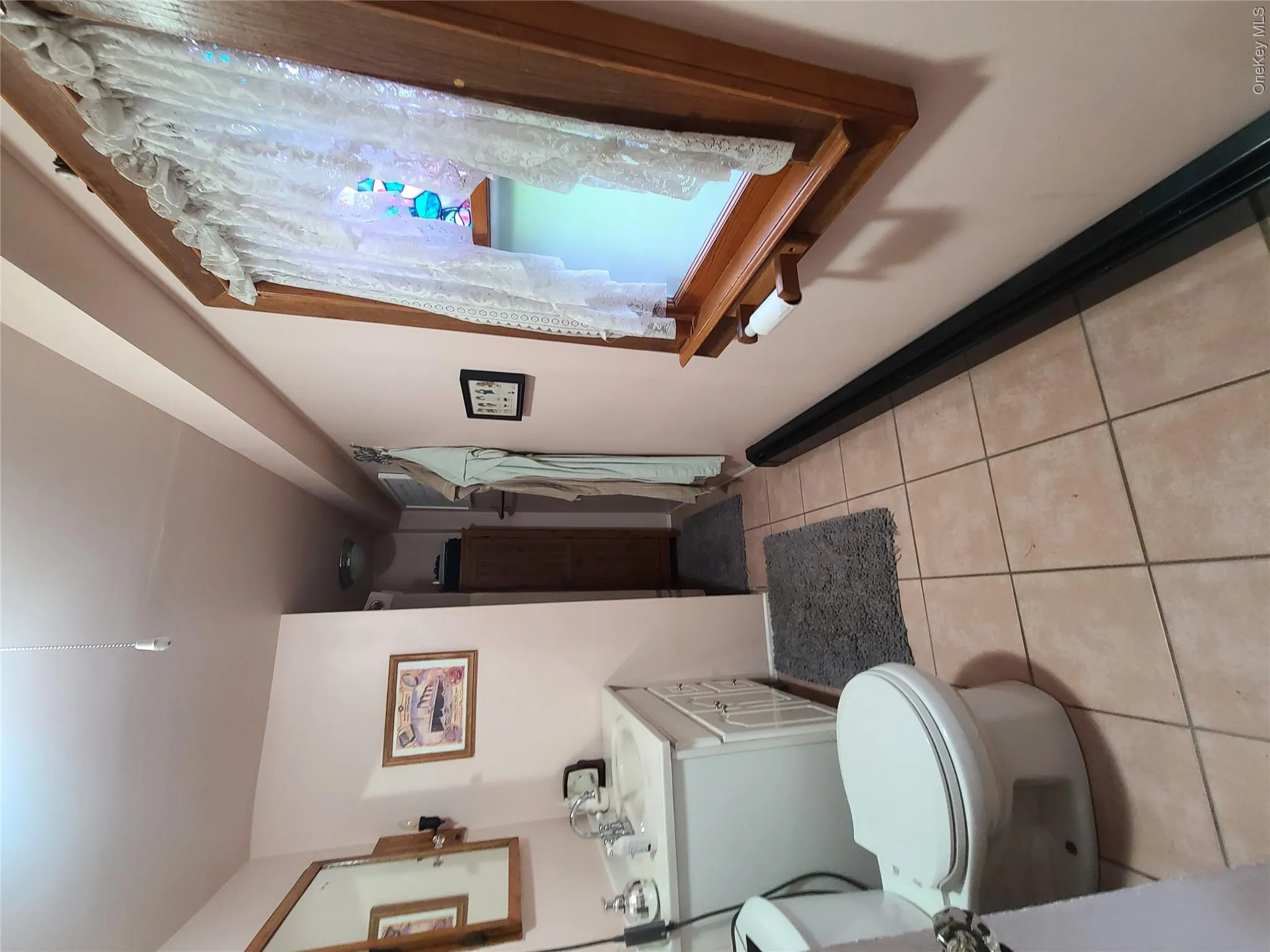 Bathroom featuring tile patterned flooring and vanity Bathroom featuring tile patterned flooring and vanity