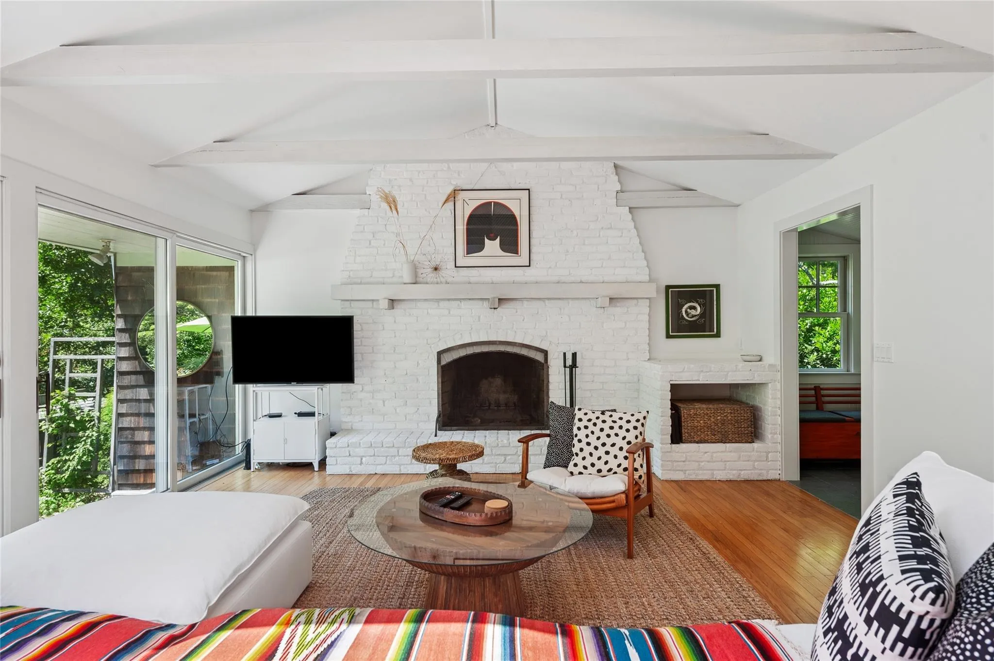 Living room featuring a fireplace and wood finished floors Living room featuring a fireplace and wood finished floors