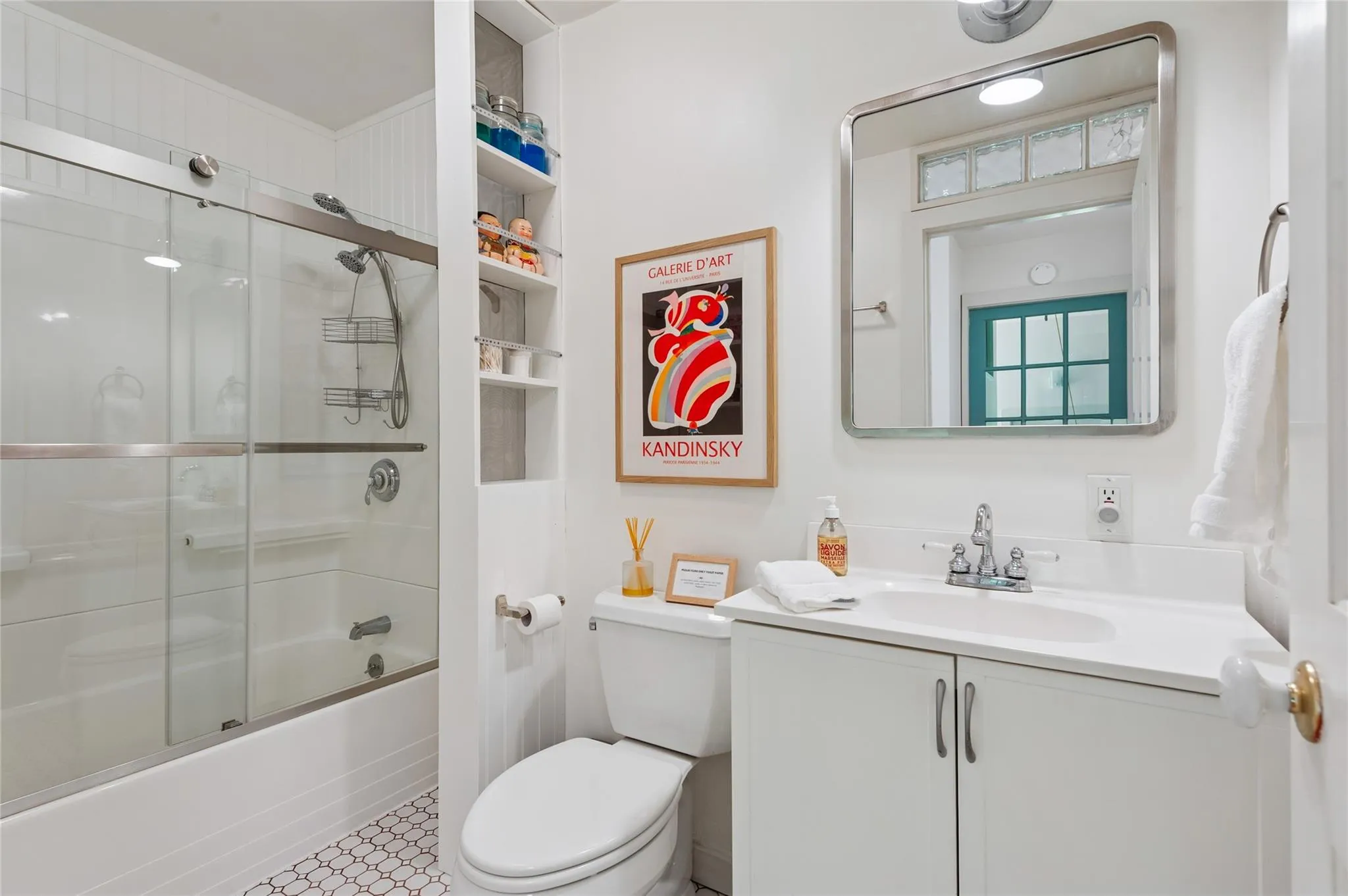 Full bathroom featuring vanity, combined bath / shower with glass door, and built in features Full bathroom featuring vanity, combined bath / shower with glass door, and built in features