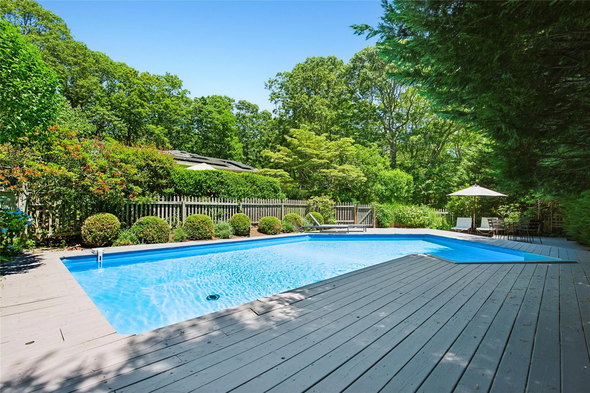 View of pool featuring a wooden deck View of pool featuring a wooden deck