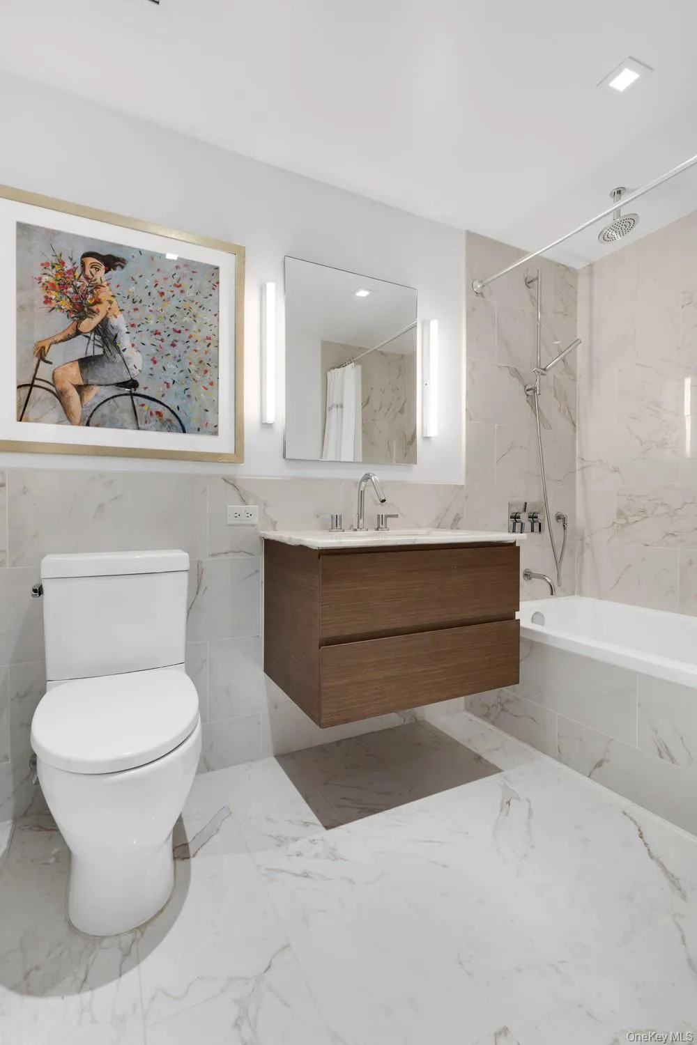 Full bathroom featuring vanity, a combined bath / shower with marble appearance, tile walls, and marble finish floors Full bathroom featuring vanity, a combined bath / shower with marble appearance, tile walls, and marble finish floors