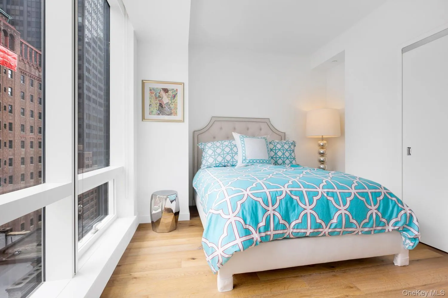 Bedroom featuring wood finished floors and baseboards Bedroom featuring wood finished floors and baseboards
