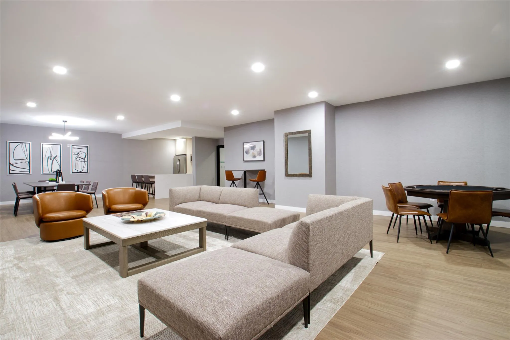 Living room featuring light wood-style floors, recessed lighting, and a chandelier Living room featuring light wood-style floors, recessed lighting, and a chandelier