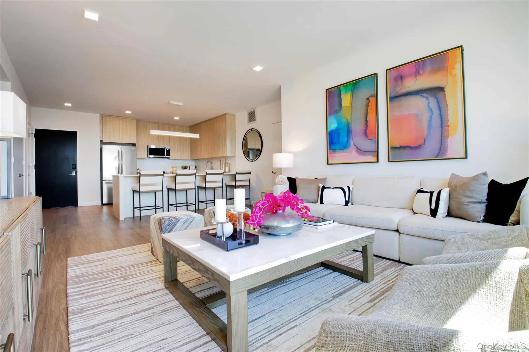 Living room featuring light wood-style floors and recessed lighting Living room featuring light wood-style floors and recessed lighting