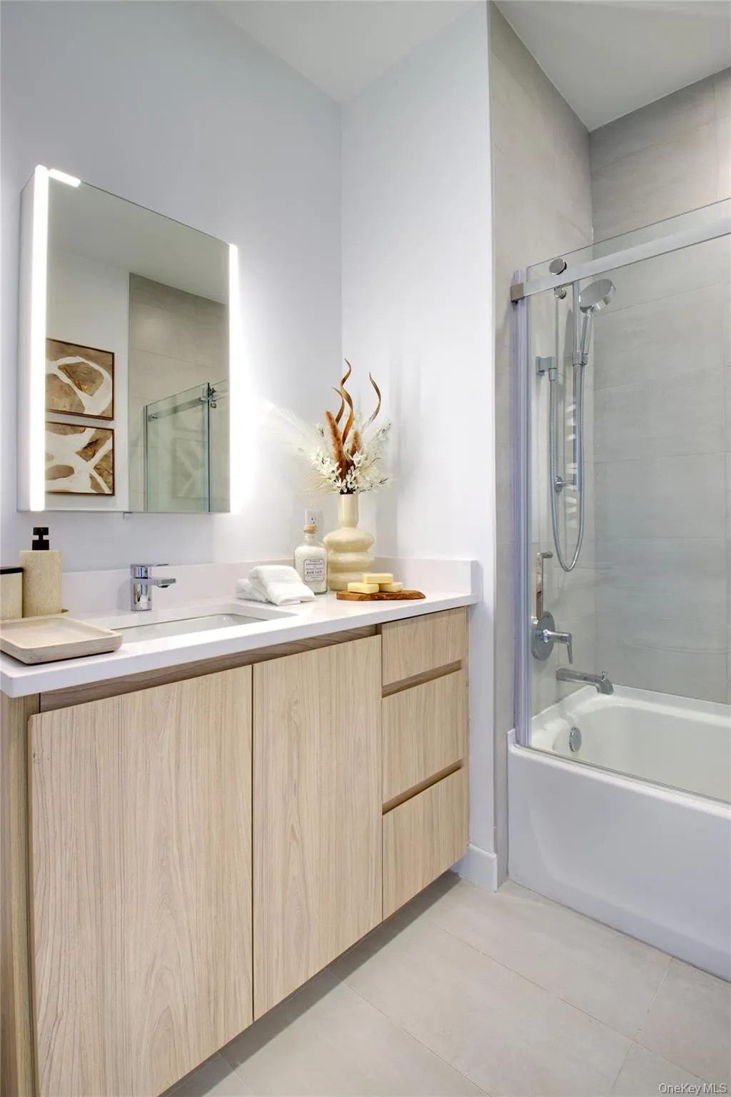 Full bathroom featuring vanity, shower / bath combination, and tile patterned floors Full bathroom featuring vanity, shower / bath combination, and tile patterned floors