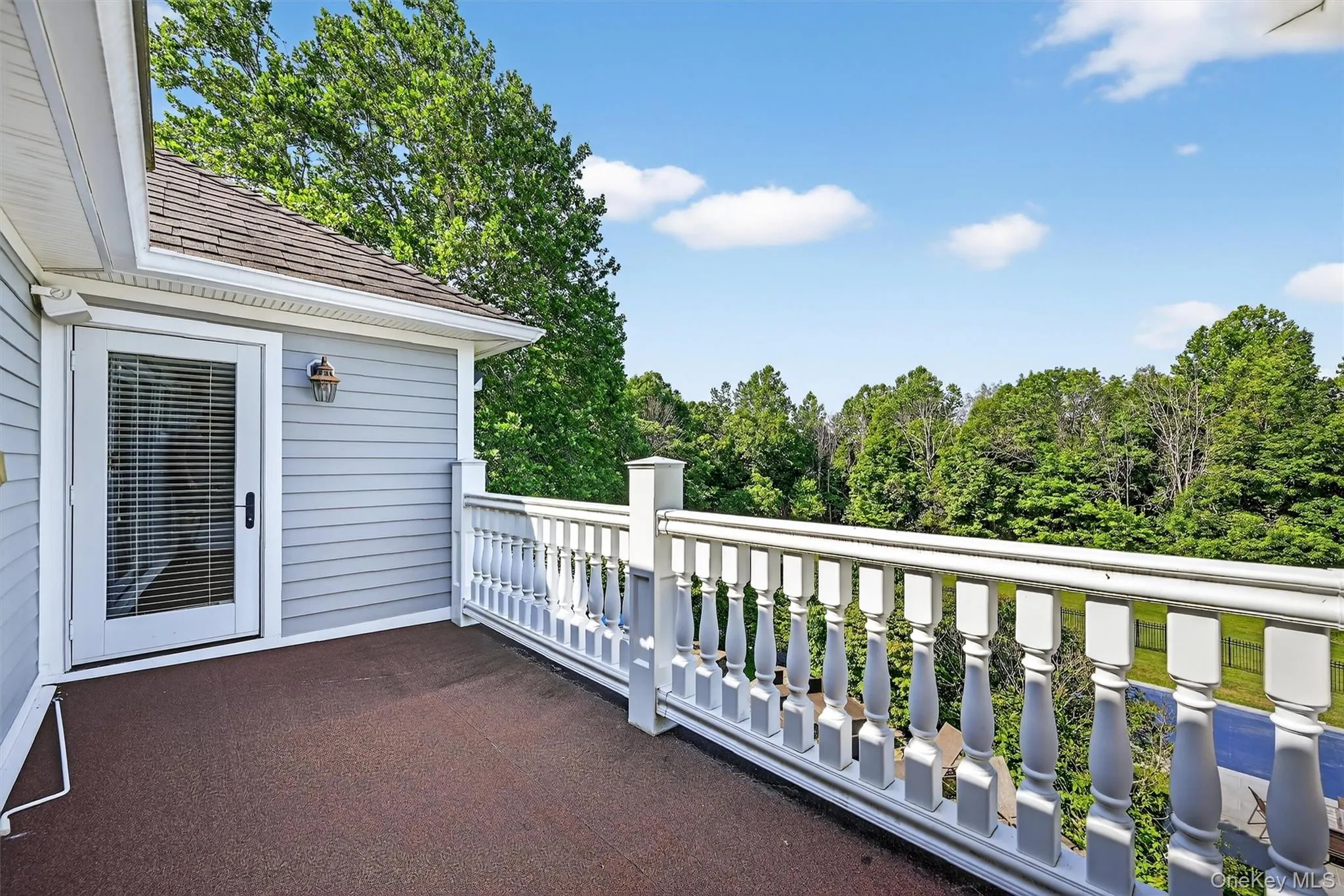 View of balcony accessible from 2 different bedrooms and primary bath View of balcony accessible from 2 different bedrooms and primary bath