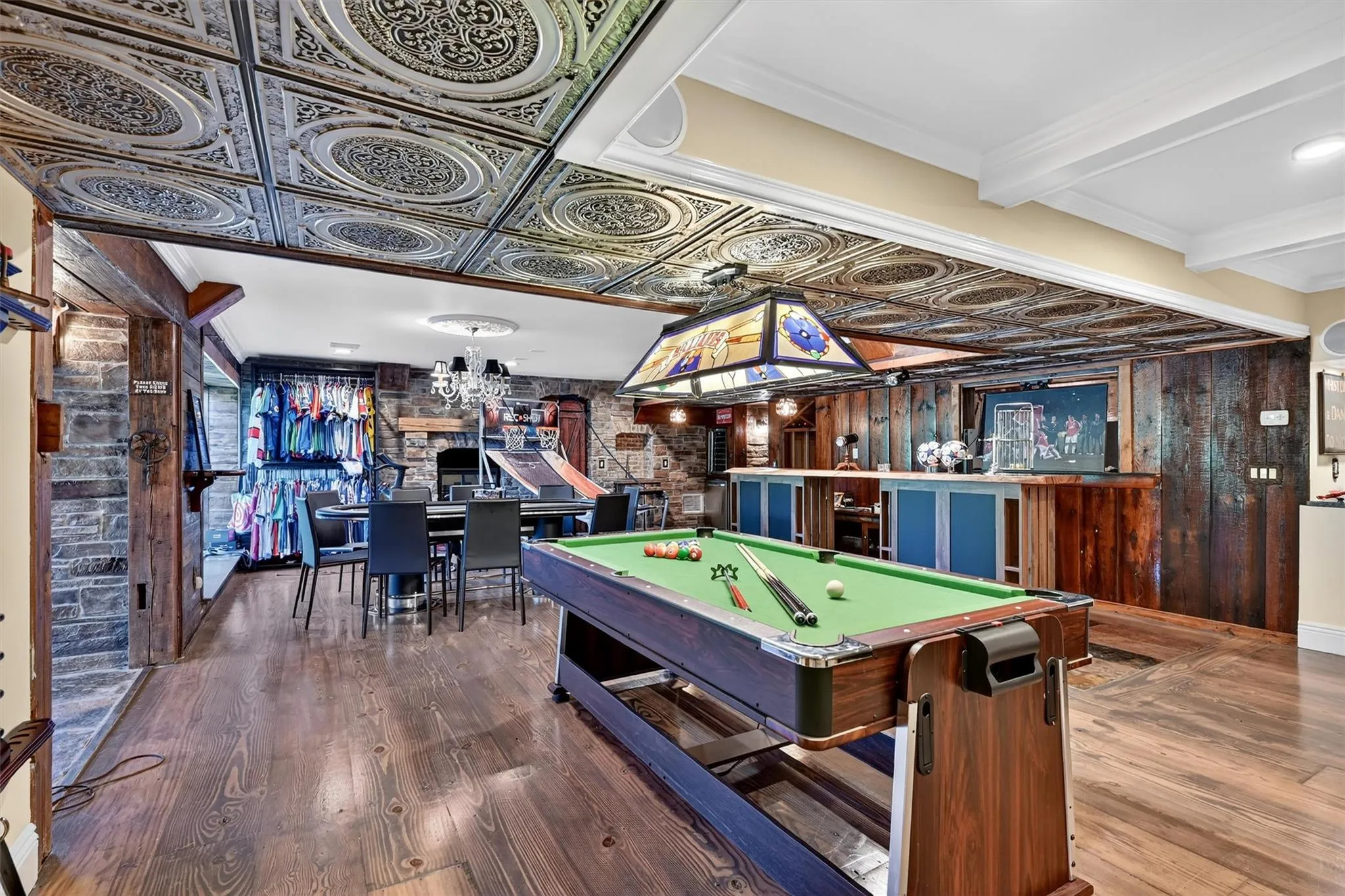 Rec room featuring wood finished floors, pool table, a chandelier, and beam ceiling Rec room featuring wood finished floors, pool table, a chandelier, and beam ceiling