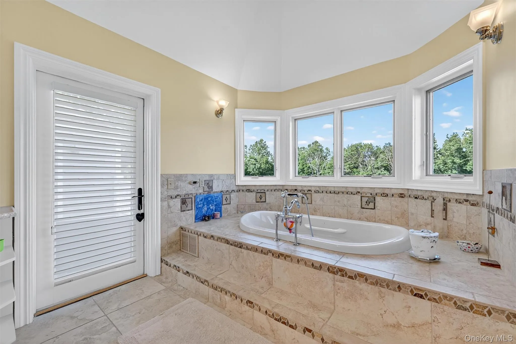 Full bathroom featuring a garden tub and tile patterned floors Full bathroom featuring a garden tub and tile patterned floors