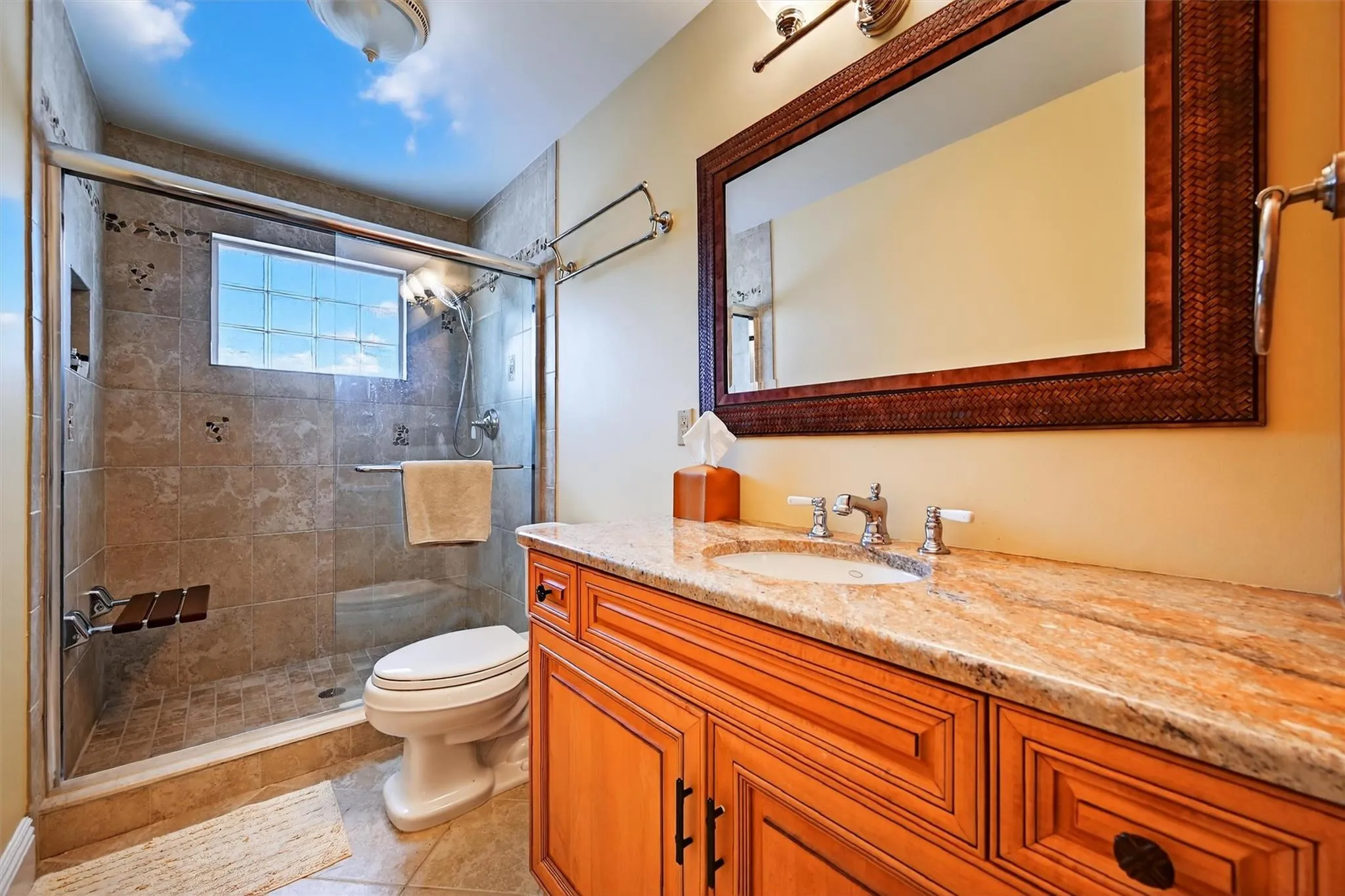 Bathroom with vanity, a stall shower, and tile patterned floors Bathroom with vanity, a stall shower, and tile patterned floors