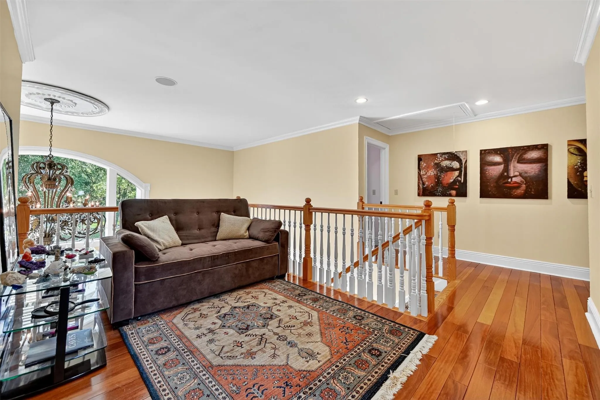 Living area featuring attic access, hardwood / wood-style floors, ornamental molding, and recessed lighting Living area featuring attic access, hardwood / wood-style floors, ornamental molding, and recessed lighting