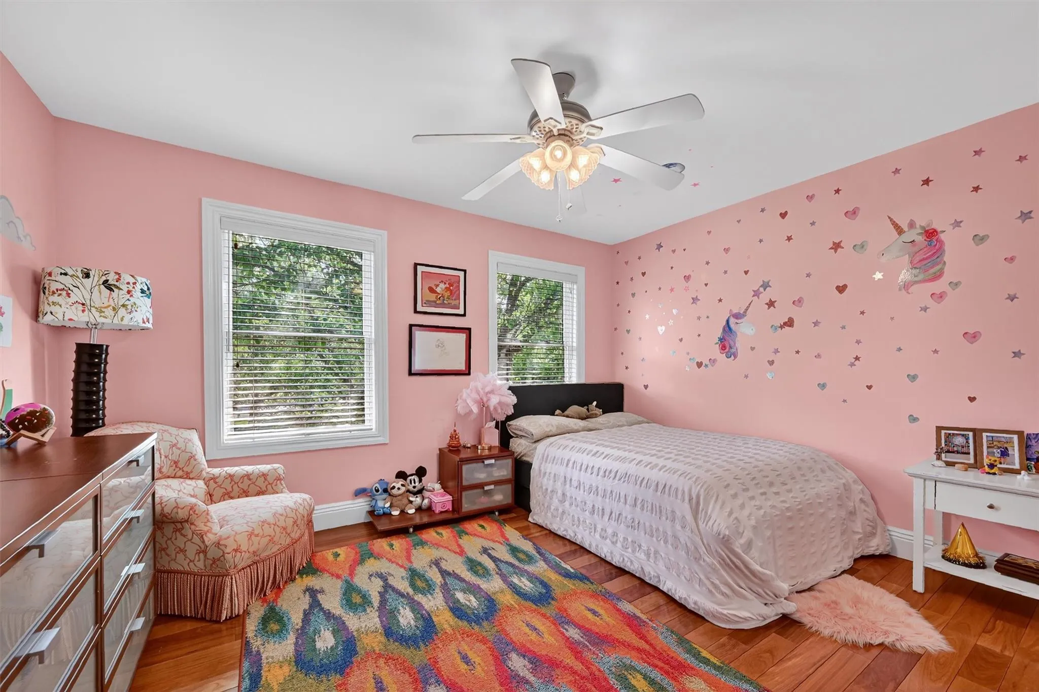 Bedroom featuring light wood finished floors and a ceiling fan Bedroom featuring light wood finished floors and a ceiling fan