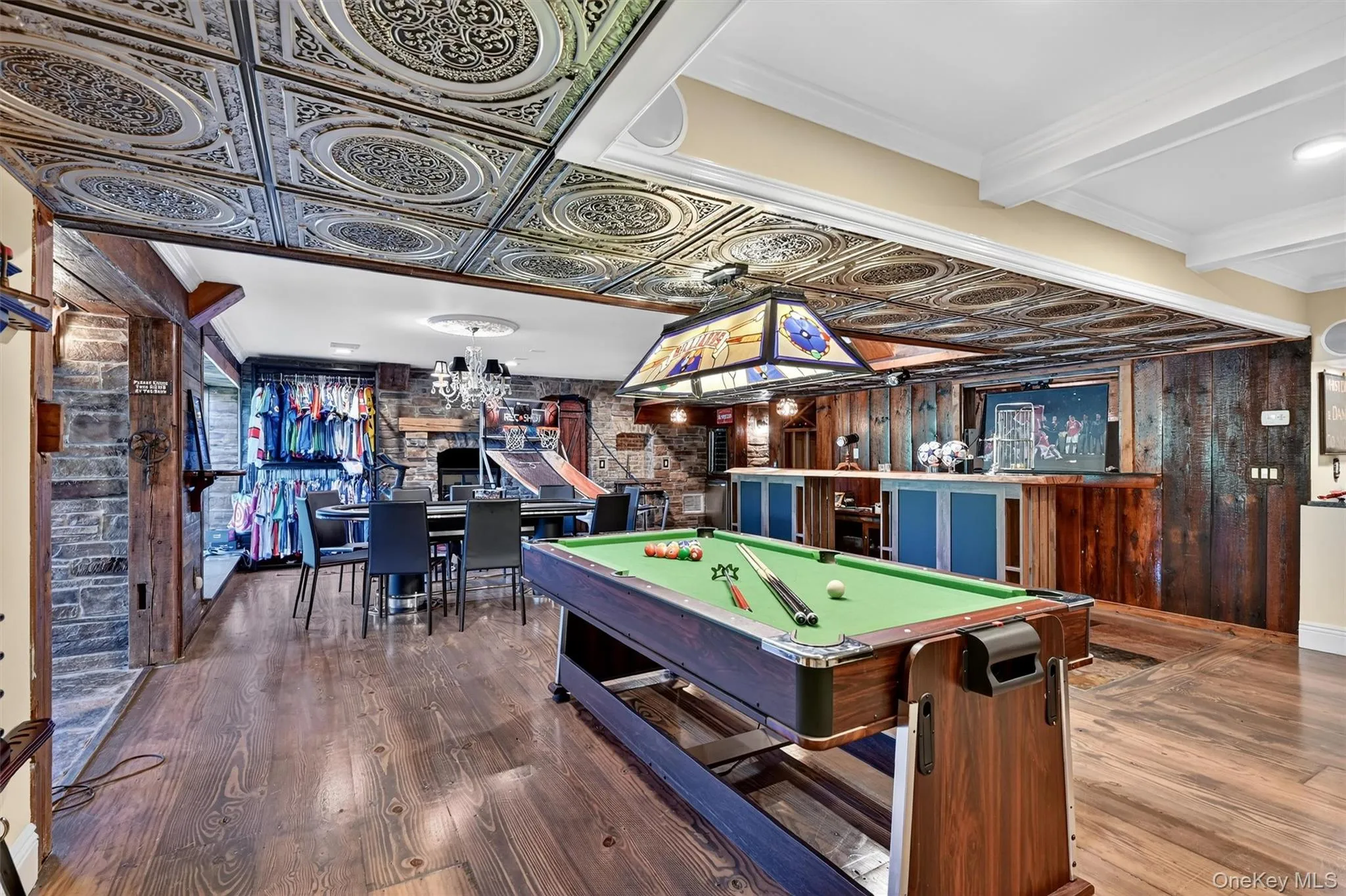 Rec room featuring wood finished floors, pool table, a chandelier, and beam ceiling Rec room featuring wood finished floors, pool table, a chandelier, and beam ceiling
