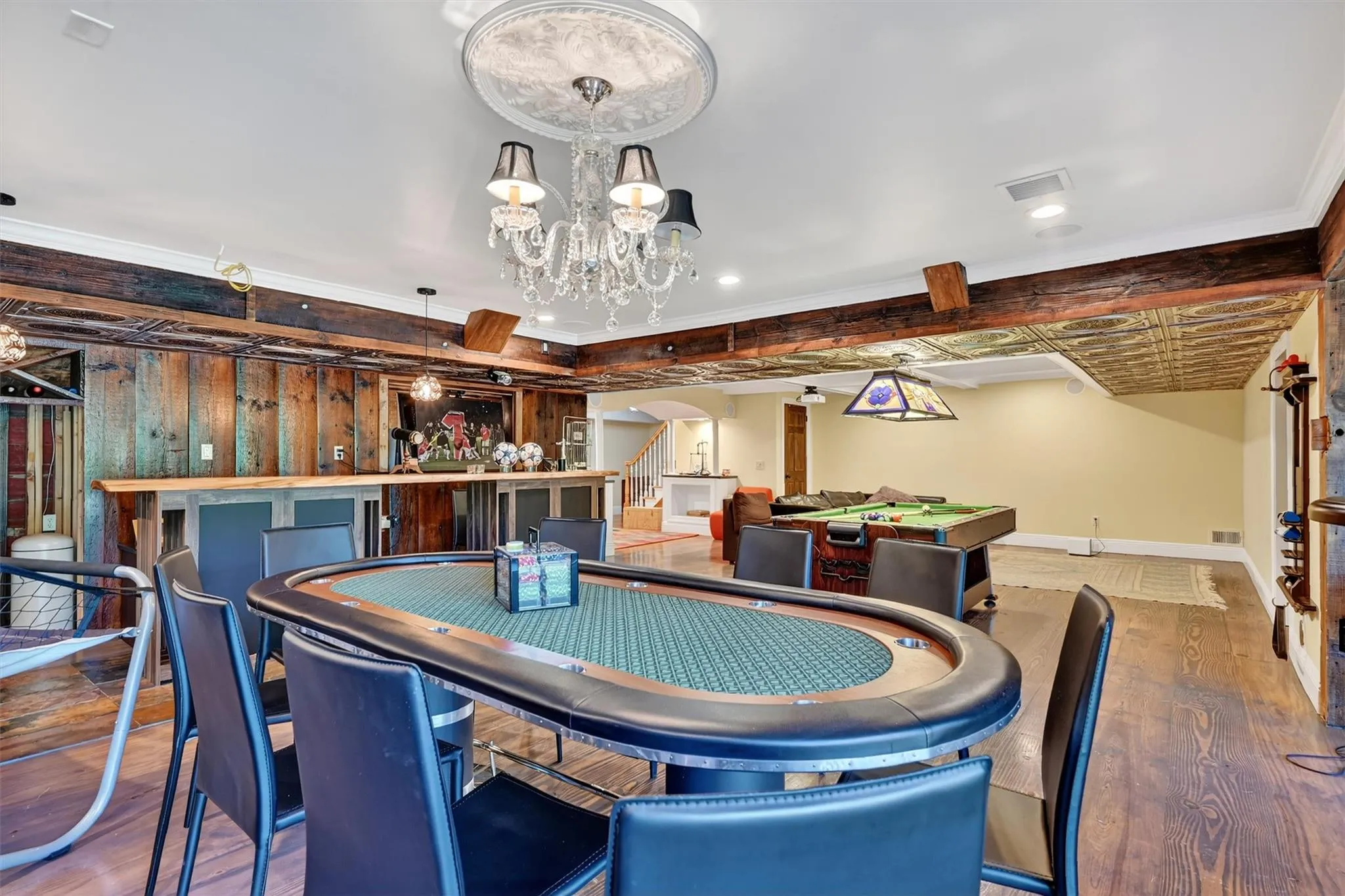 Dining area with wood finished floors, arched walkways, a chandelier, stairway, and recessed lighting Dining area with wood finished floors, arched walkways, a chandelier, stairway, and recessed lighting