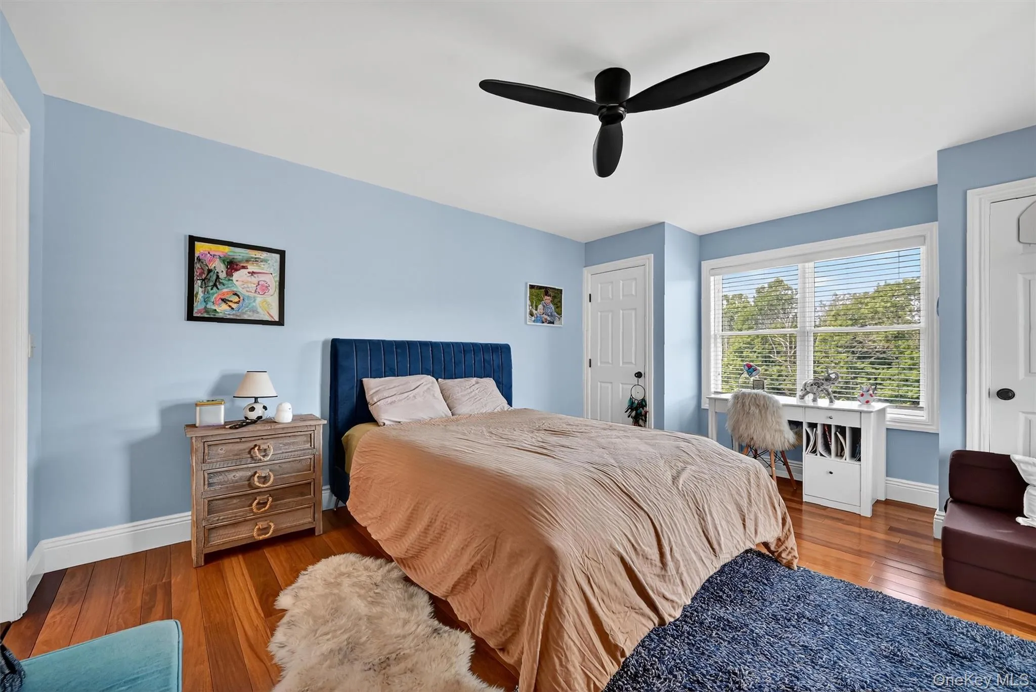Bedroom featuring wood finished floors and a ceiling fan Bedroom featuring wood finished floors and a ceiling fan