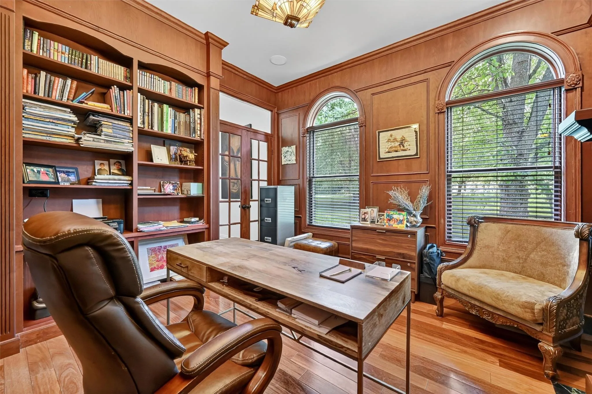 Office featuring light wood-type flooring, ornamental molding, french doors, and wooden walls Office featuring light wood-type flooring, ornamental molding, french doors, and wooden walls