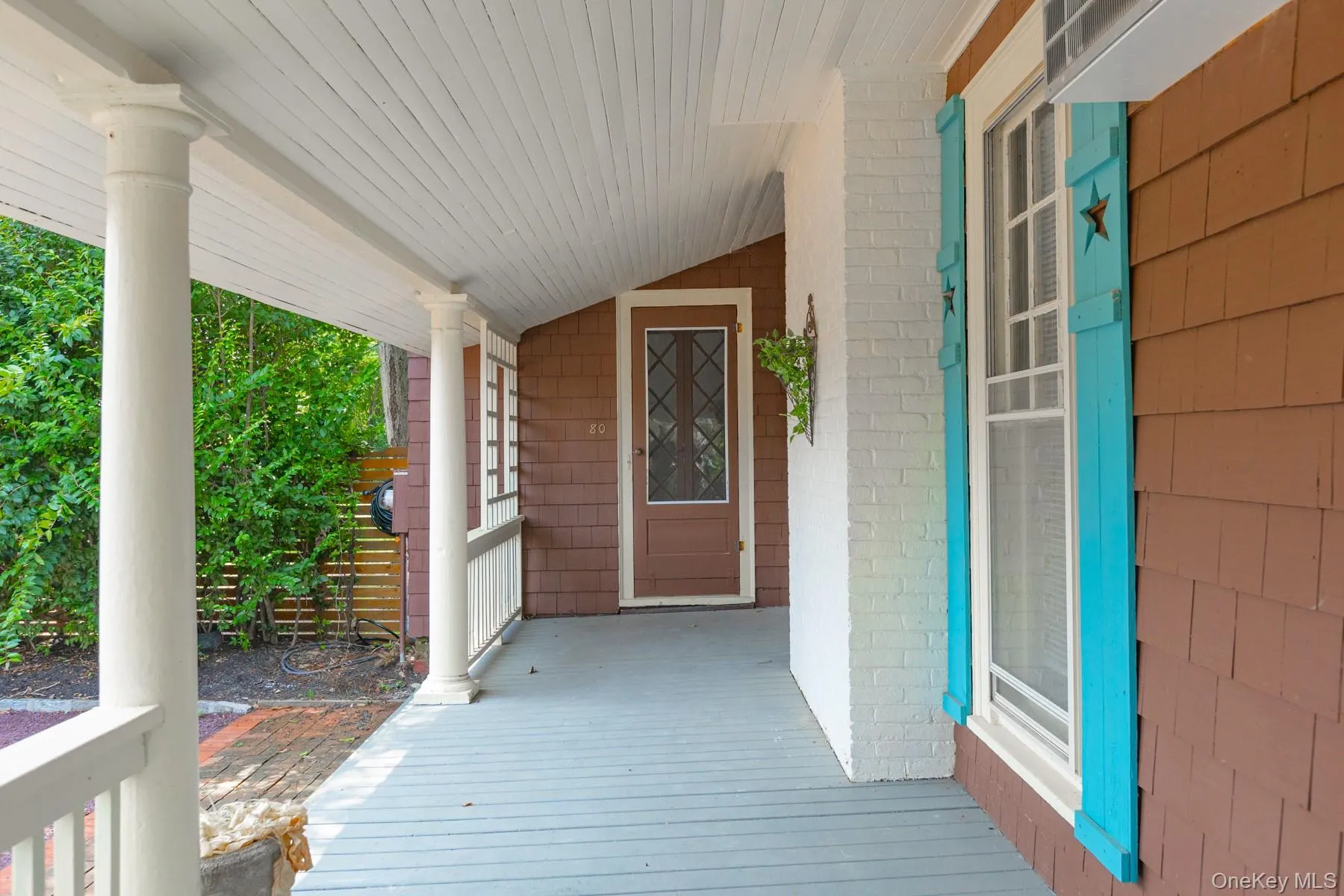Doorway to property featuring covered porch and brick siding Doorway to property featuring covered porch and brick siding