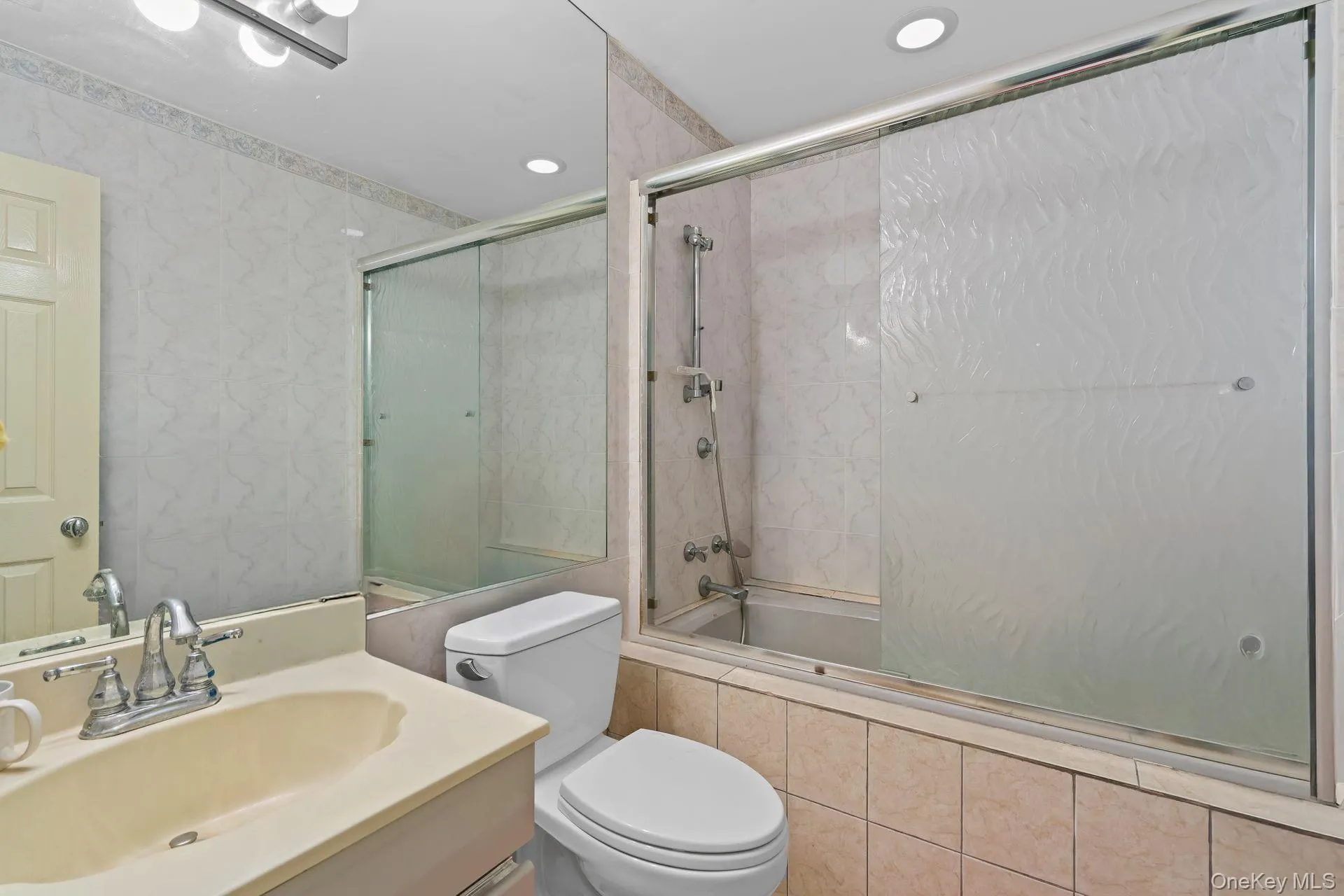 Full bath with tiled shower / bath combo, vanity, and recessed lighting Full bath with tiled shower / bath combo, vanity, and recessed lighting