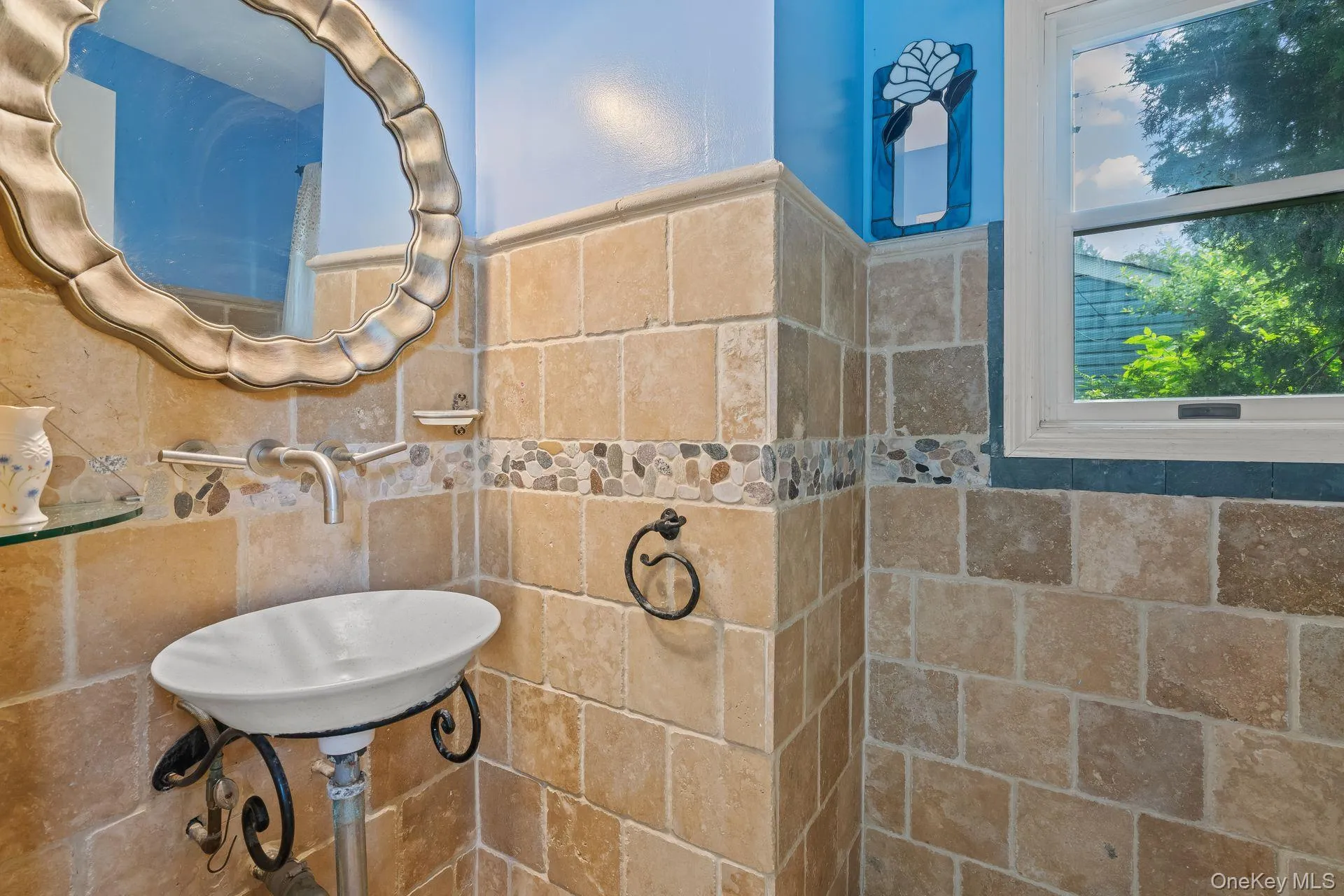 Bathroom with a sink and tile walls Bathroom with a sink and tile walls