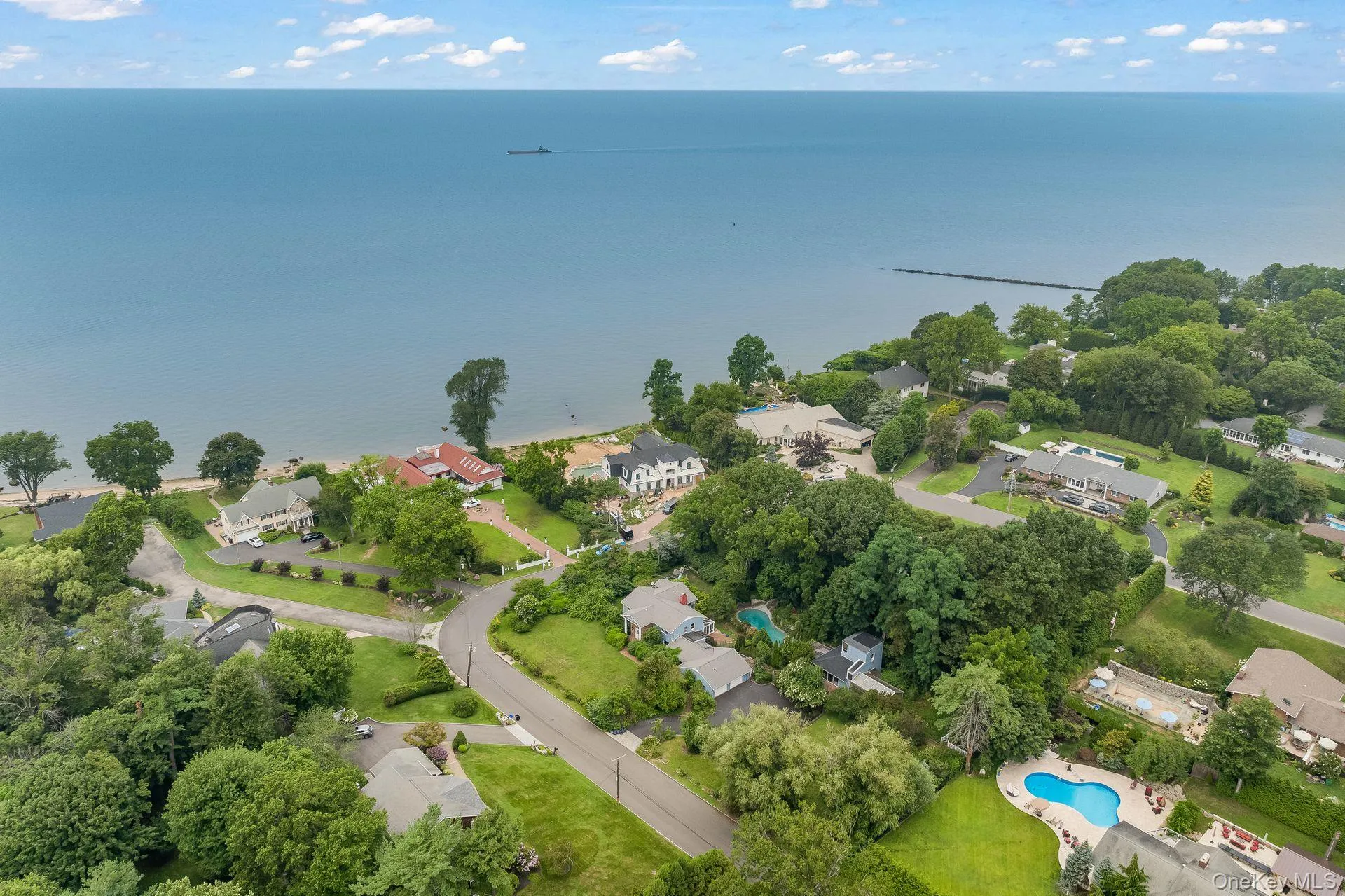 Aerial perspective of suburban area featuring a large body of water Aerial perspective of suburban area featuring a large body of water