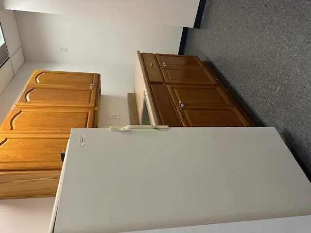 Kitchen with sink, refrigerator and counter space. Kitchen with sink, refrigerator and counter space.