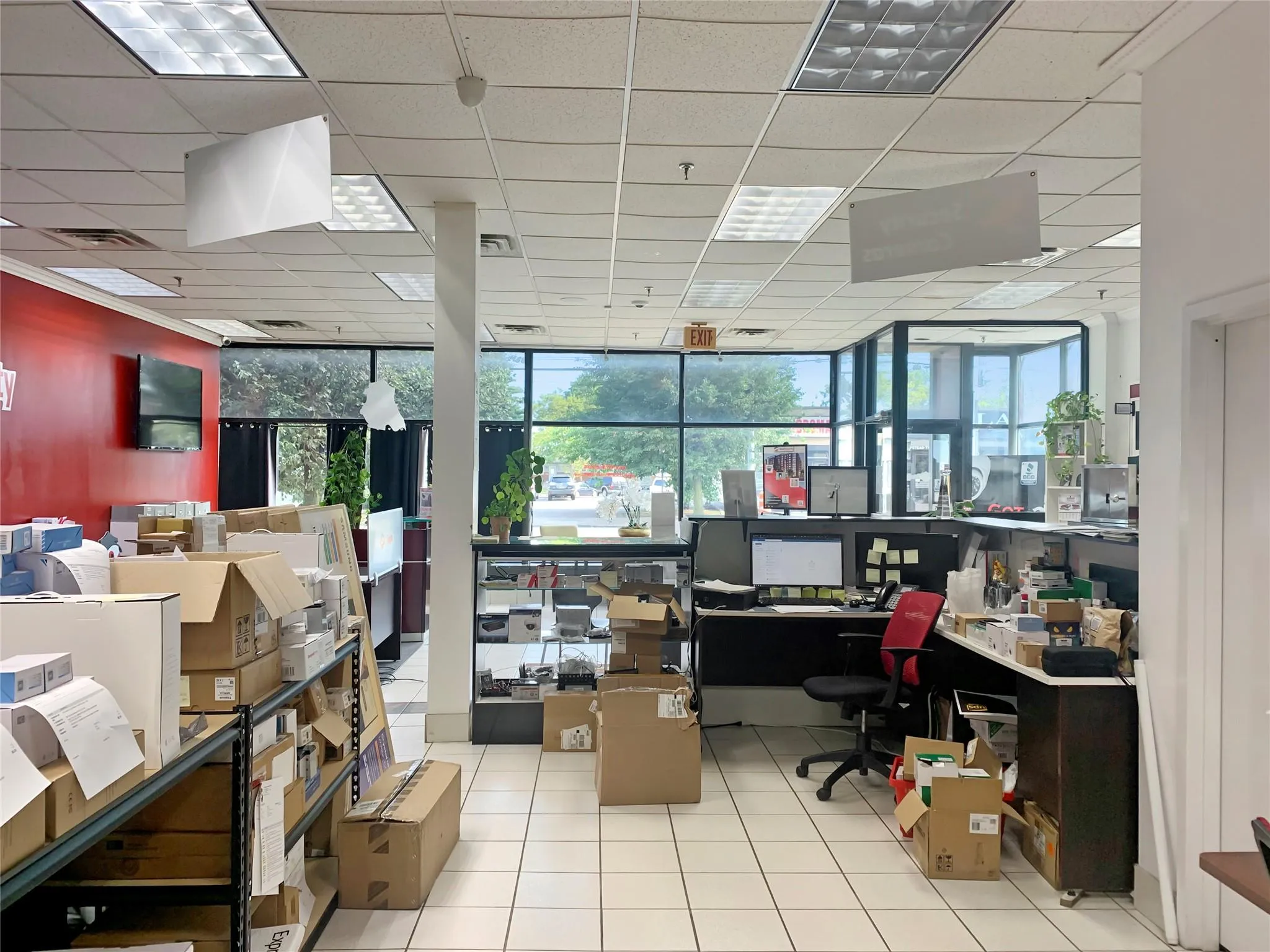 Office space with a drop ceiling, tile patterned flooring, and floor to ceiling windows Office space with a drop ceiling, tile patterned flooring, and floor to ceiling windows