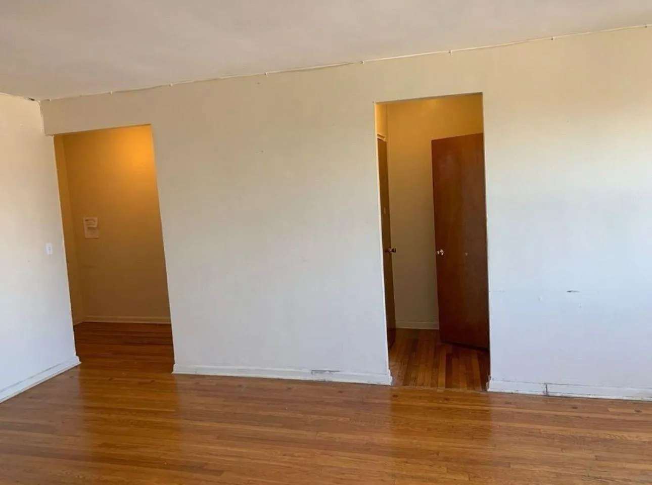 Unfurnished room featuring wood finished floors Unfurnished room featuring wood finished floors