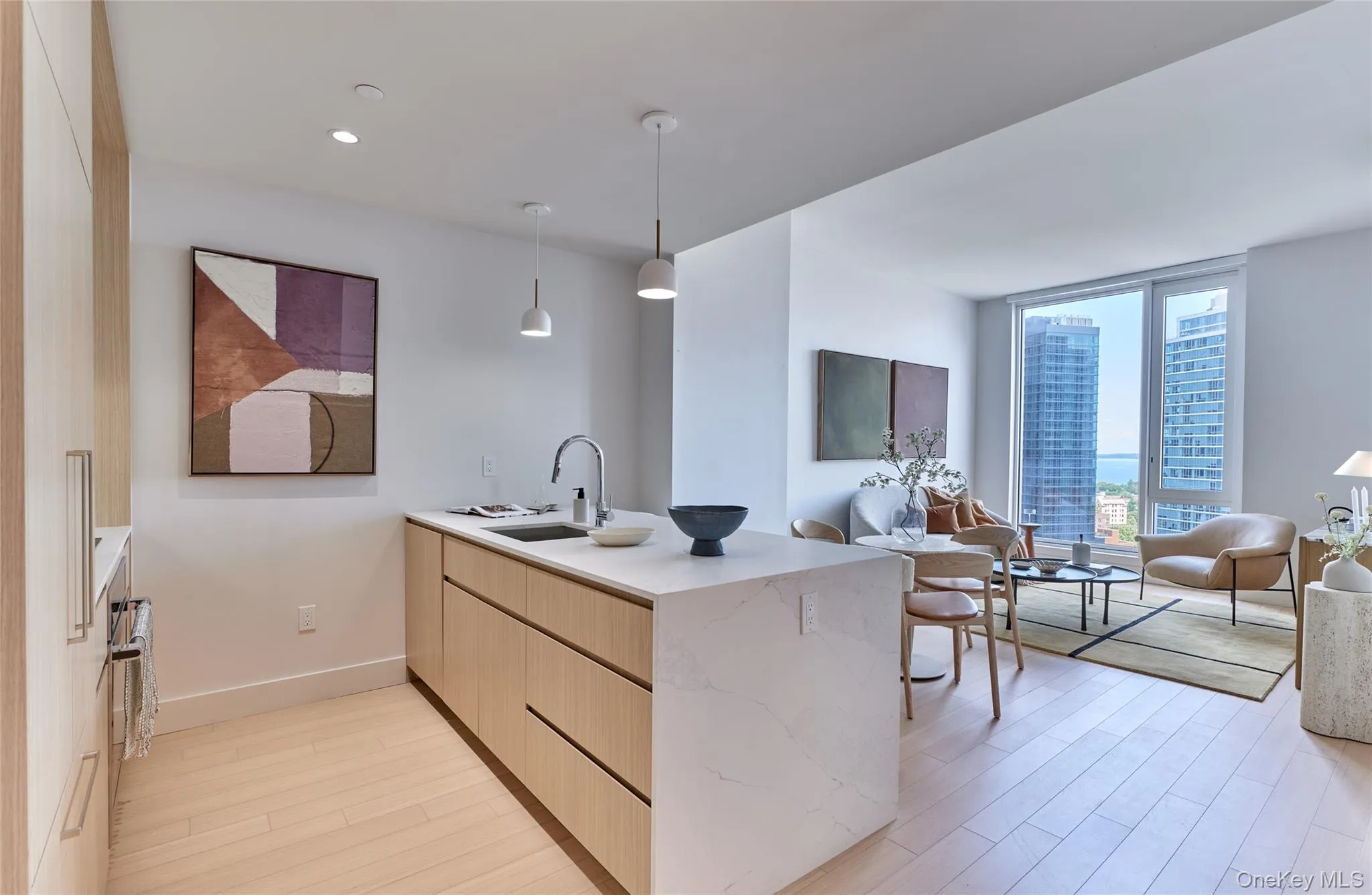 Kitchen featuring a peninsula, light wood-style flooring, light brown cabinetry, open floor plan, and modern cabinets Kitchen featuring a peninsula, light wood-style flooring, light brown cabinetry, open floor plan, and modern cabinets