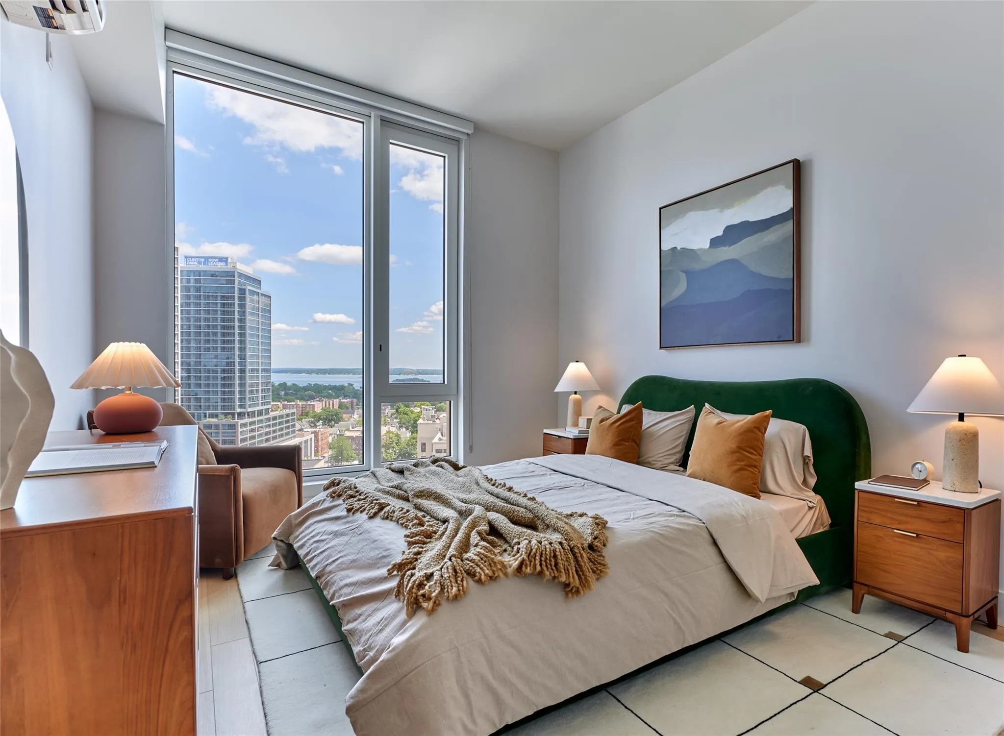 Bedroom featuring light tile patterned flooring, a wall of windows, a city view, and a wall mounted AC Bedroom featuring light tile patterned flooring, a wall of windows, a city view, and a wall mounted AC