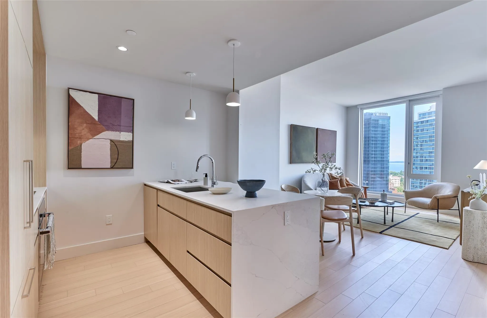 Kitchen featuring a peninsula, light wood-style flooring, light brown cabinetry, open floor plan, and modern cabinets Kitchen featuring a peninsula, light wood-style flooring, light brown cabinetry, open floor plan, and modern cabinets