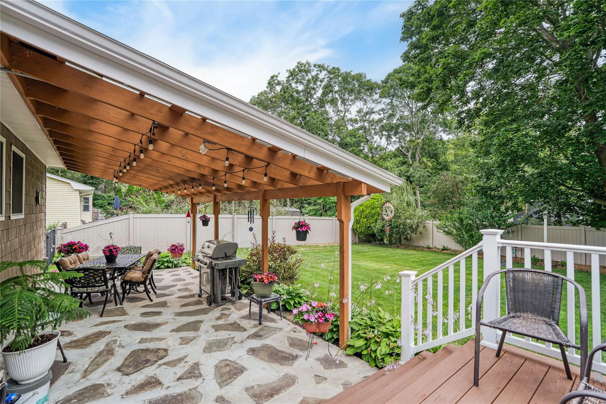 Deck featuring a fenced backyard, outdoor dining area, a grill, and a patio area