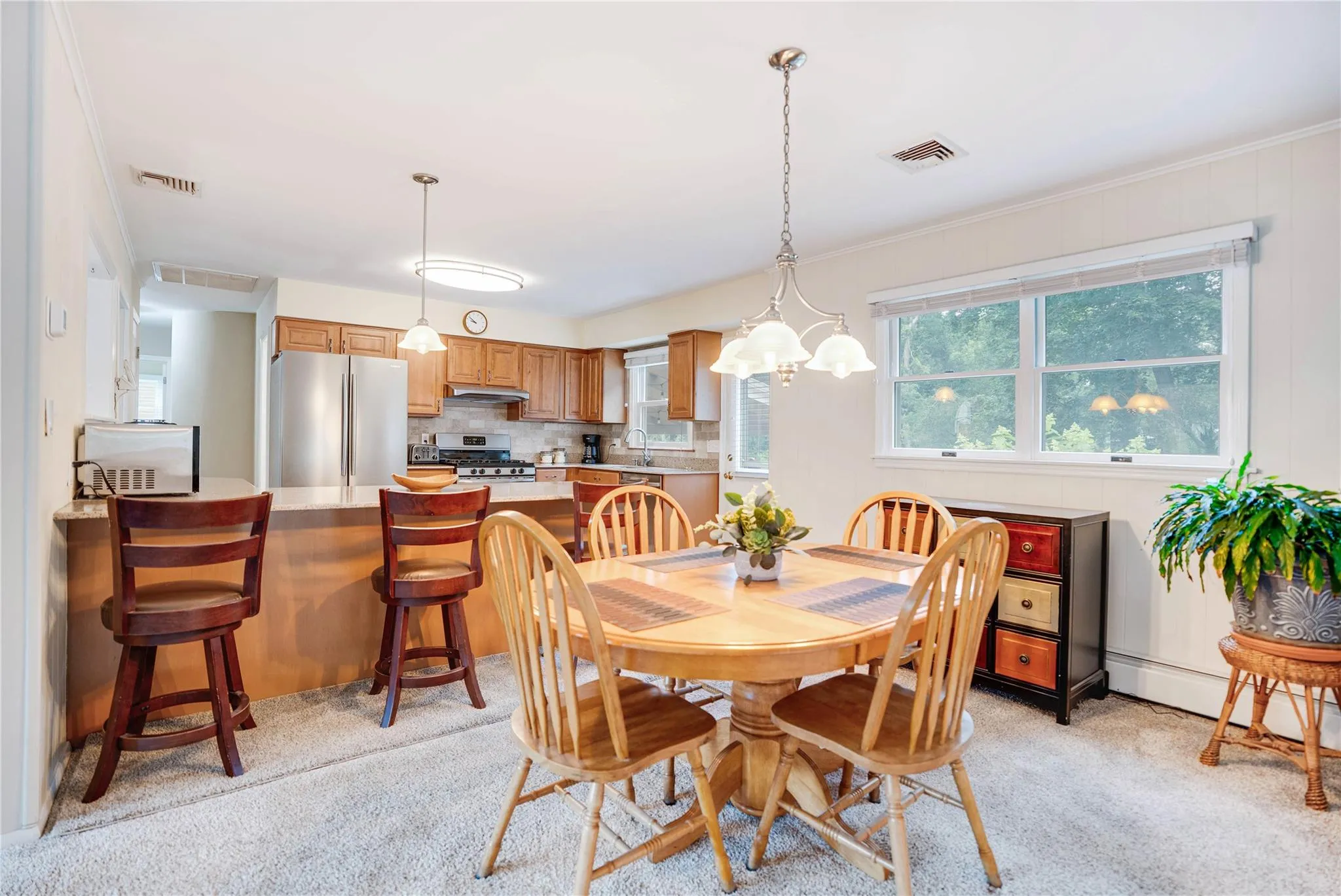 Dining space with light colored carpet