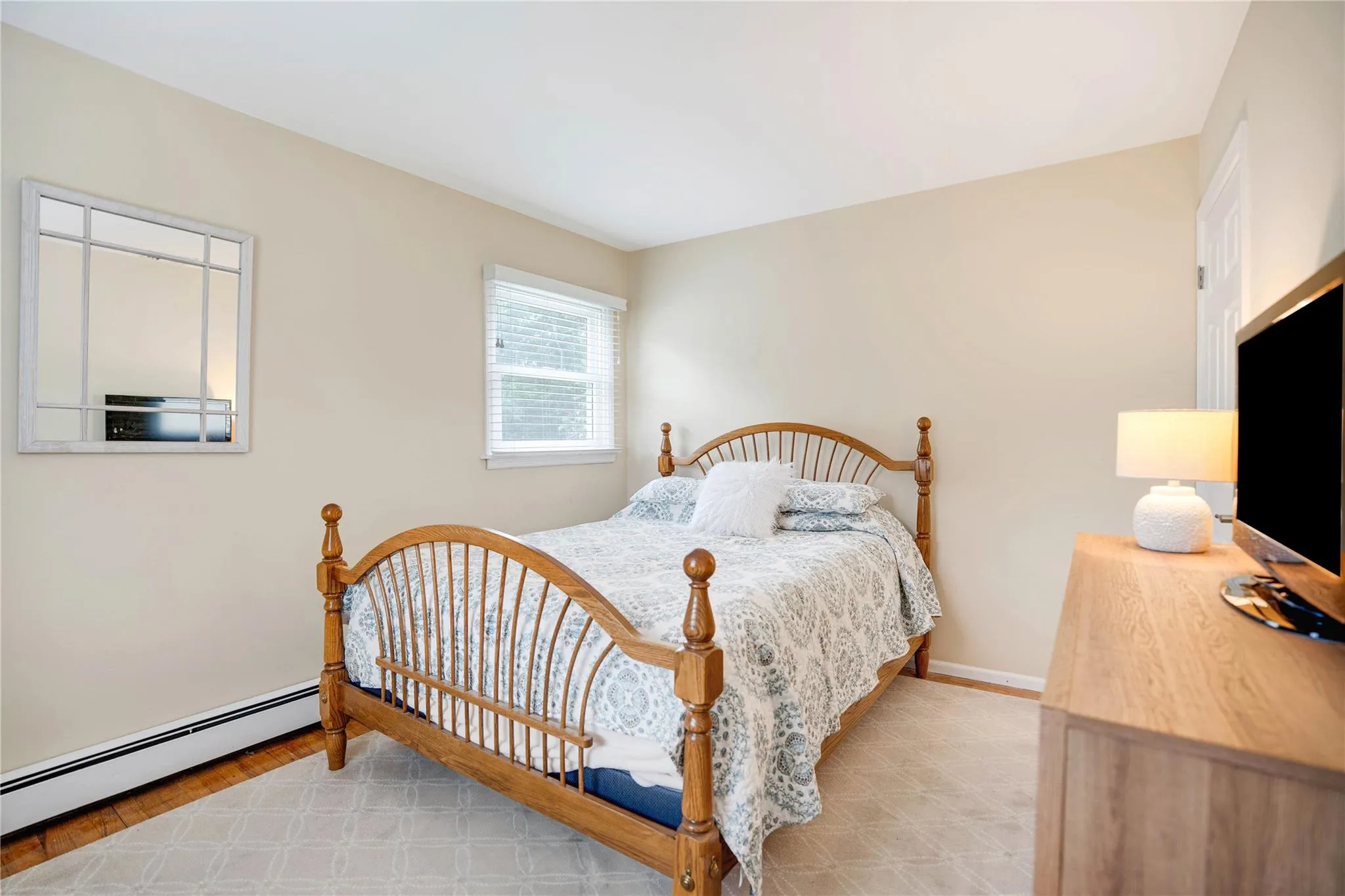 Bedroom with baseboard heating and baseboards