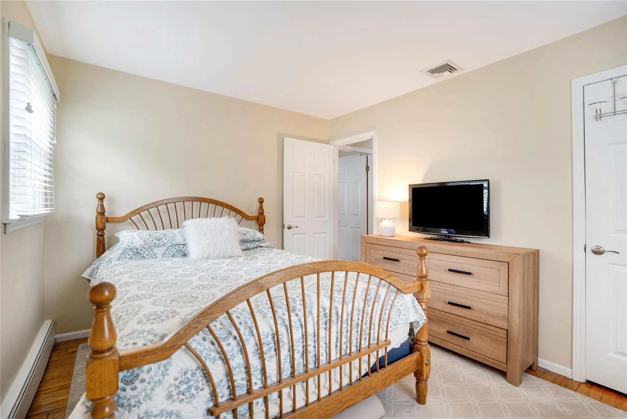 Bedroom featuring a baseboard radiator and light wood-type flooring
