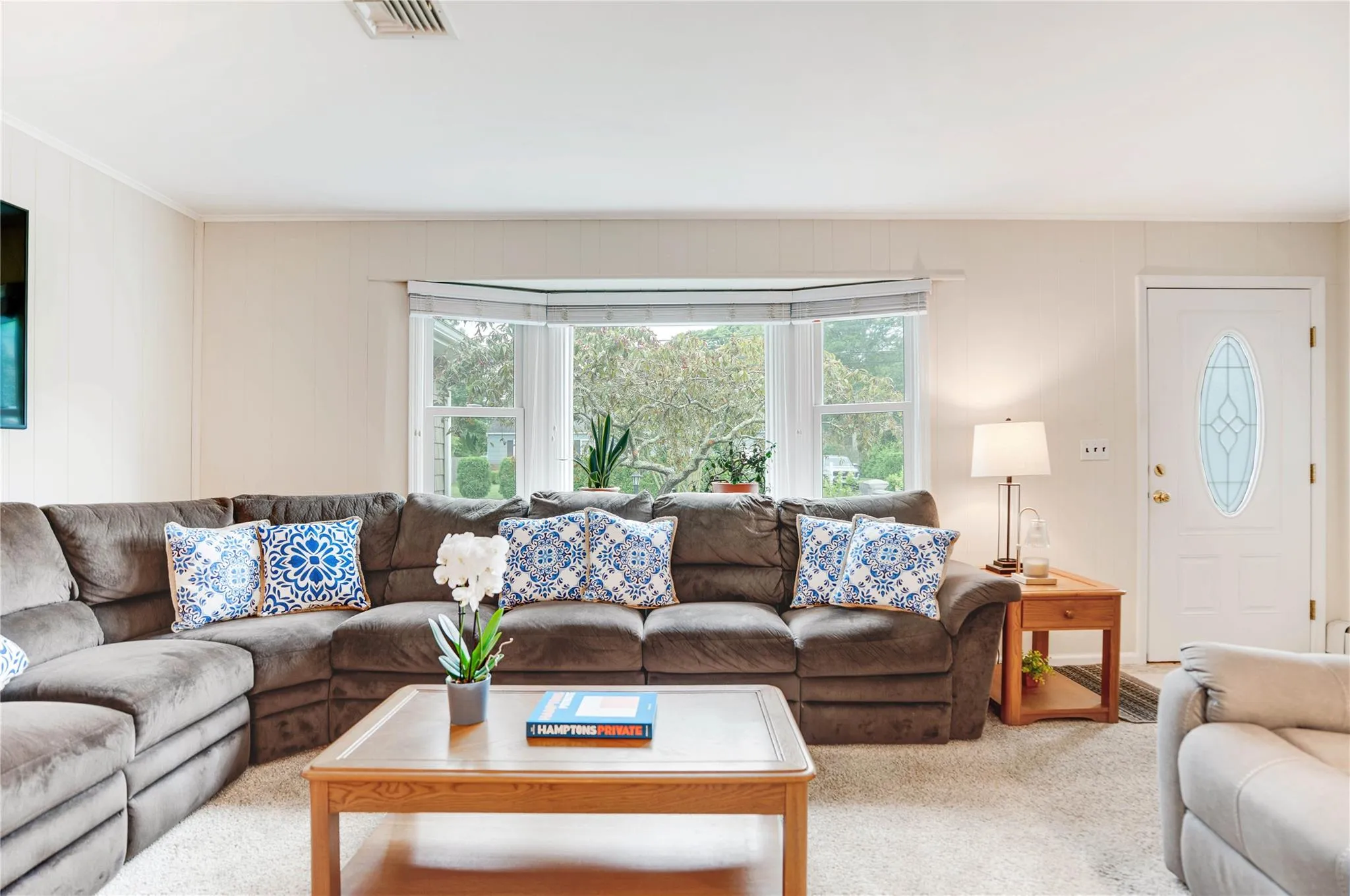 Living area with carpet and ornamental molding
