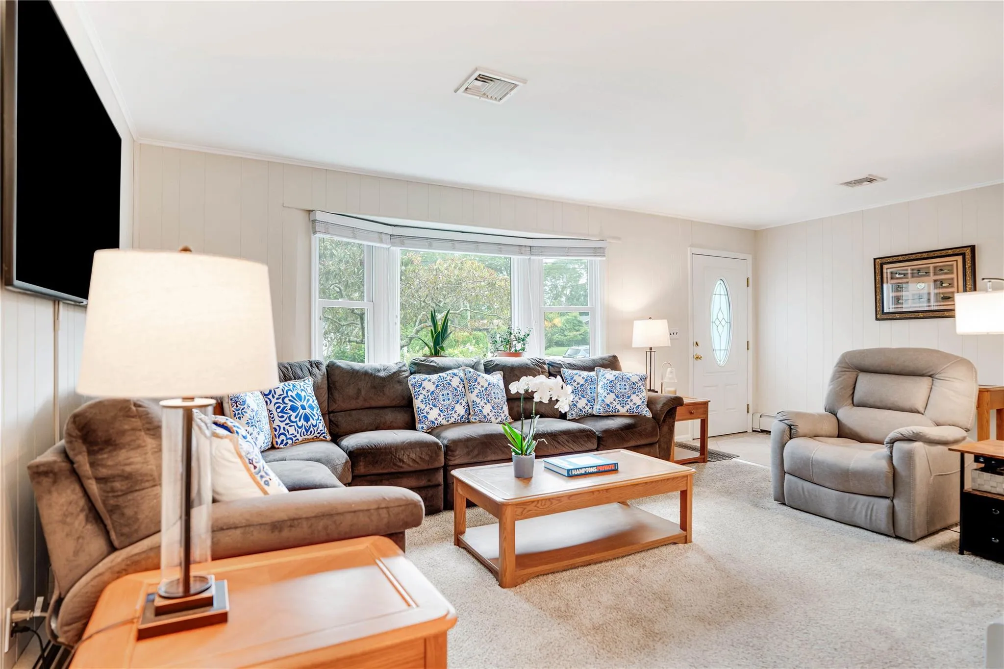Living area featuring carpet and wood walls
