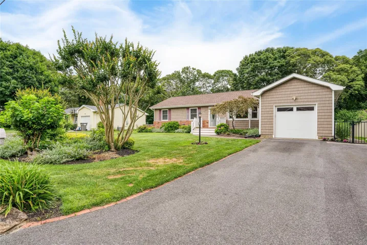 Ranch-style house with a garage and driveway