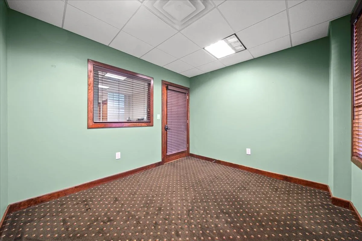 Carpeted spare room with a drop ceiling Carpeted spare room with a drop ceiling