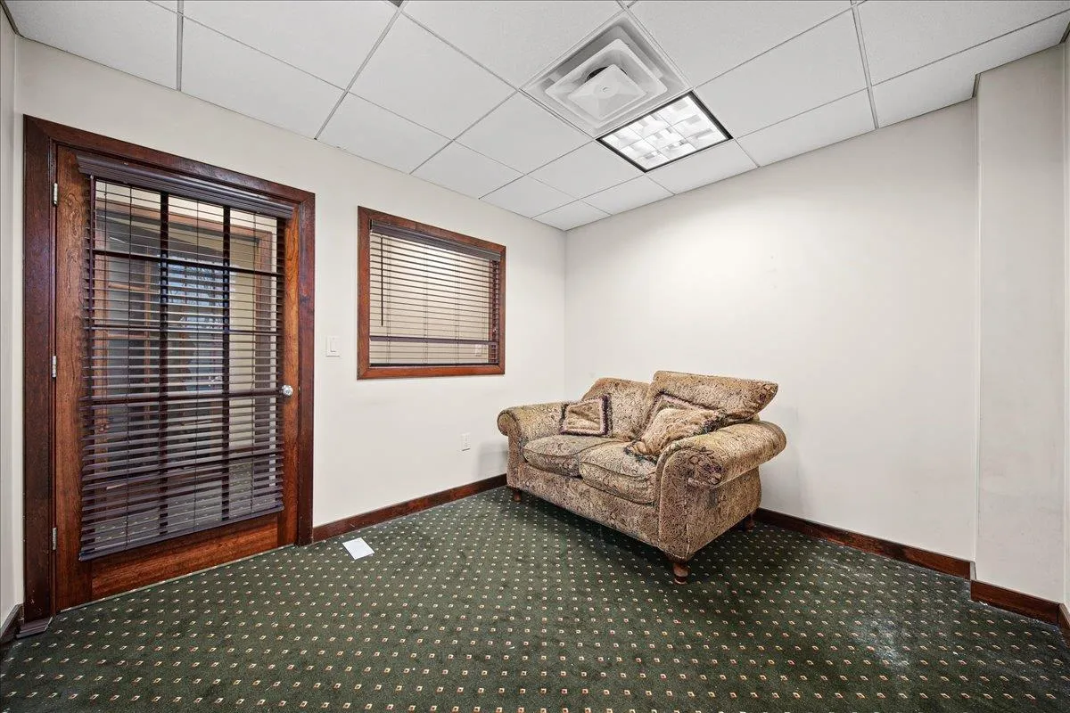 Unfurnished room with a paneled ceiling and carpet Unfurnished room with a paneled ceiling and carpet