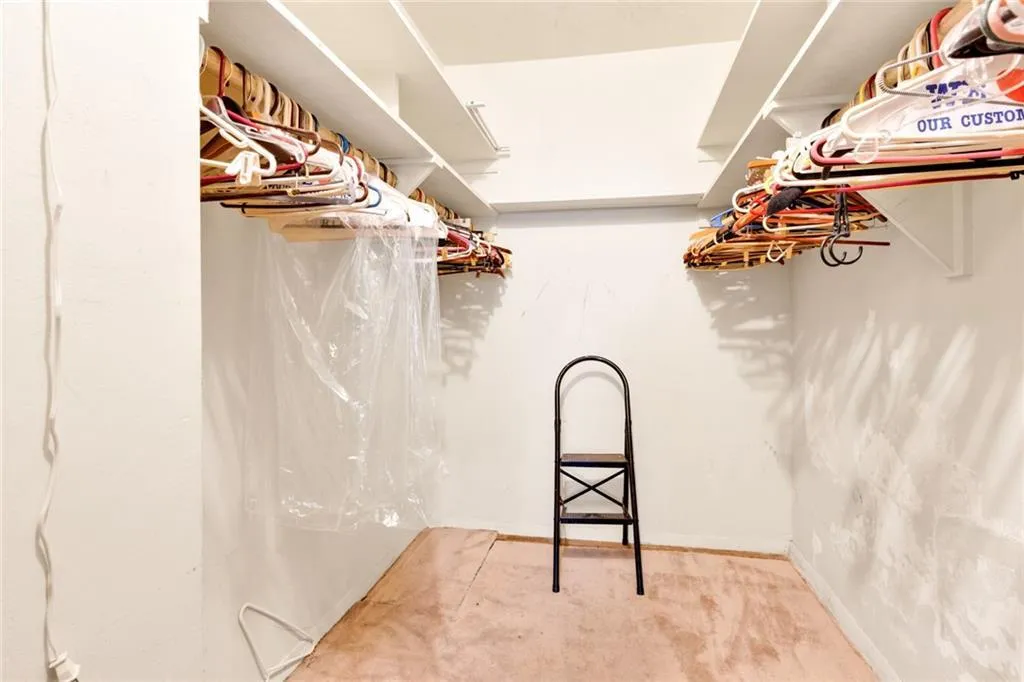 Spacious closet featuring carpet flooring Spacious closet featuring carpet flooring